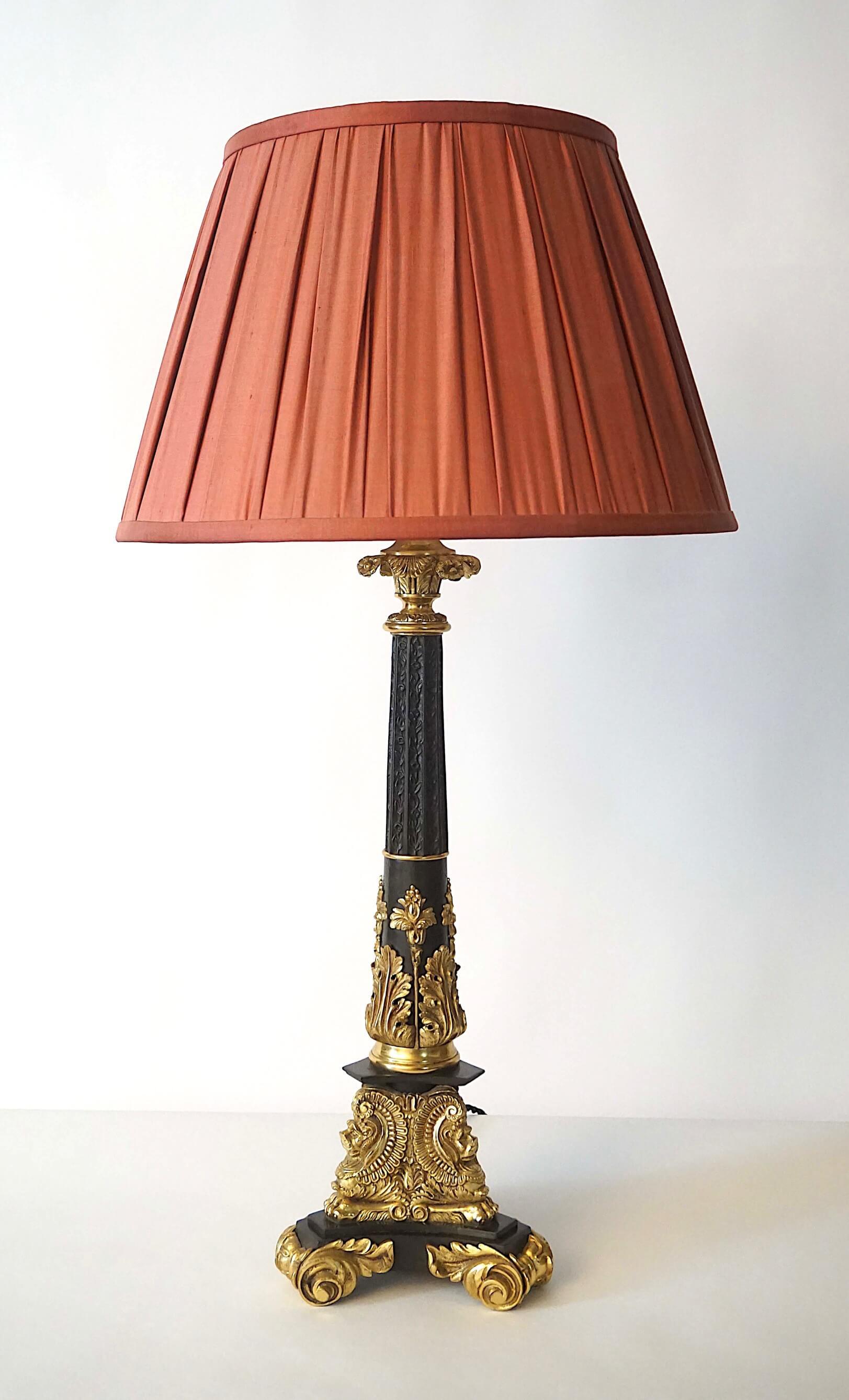 An unusual and finely cast circa 1835 English William IV or French Louis Philippe period ormolu and black-patinated solid bronze table lamp of columnular form, the base originally used as a 'sinumbra', 'astral', or 'solar' oil lamp and since