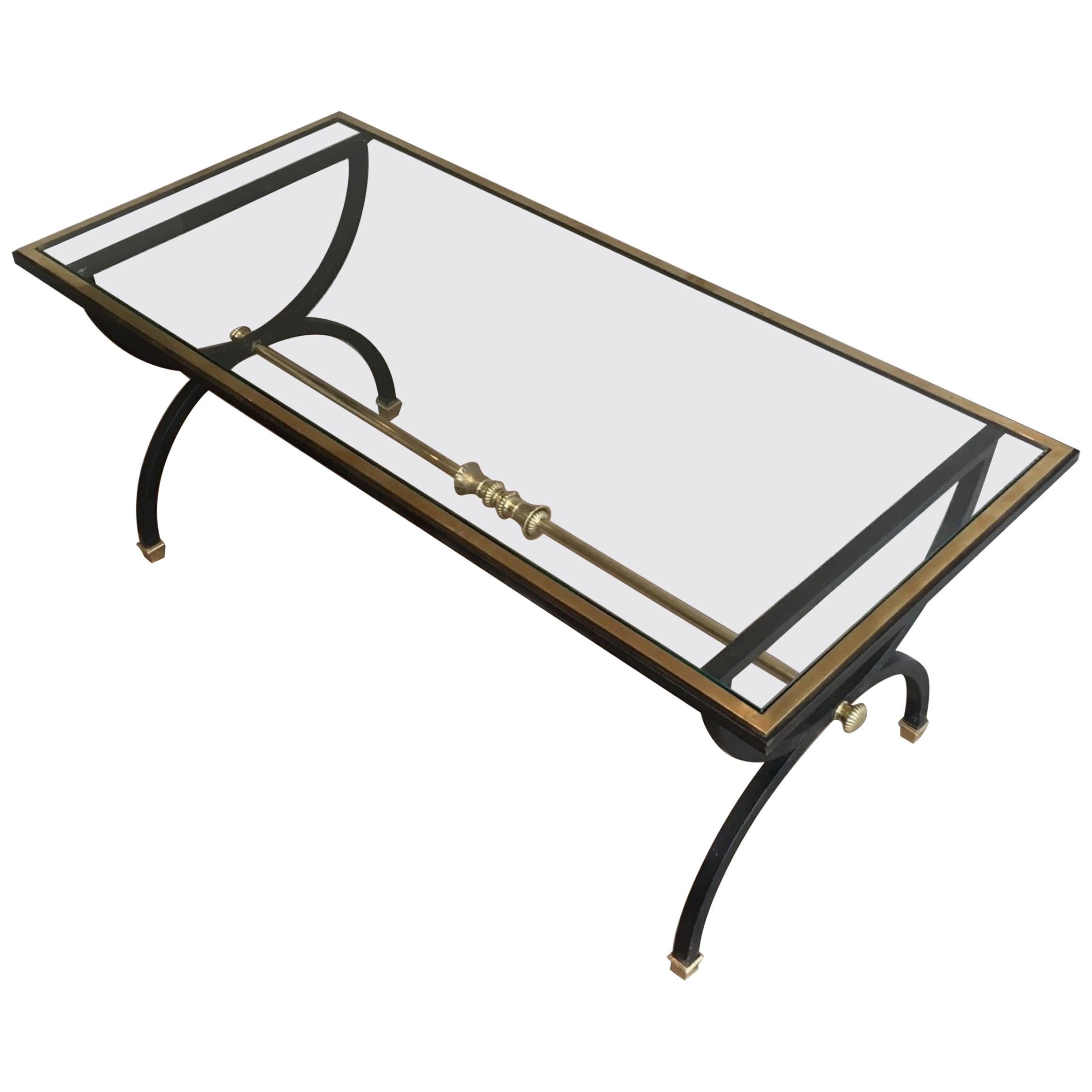 This very nice and rare neoclassical coffee table is made of black steel, bronze and brass with a glass shelf. This cocktail table is very elegant. This is a French work, circa 1950.