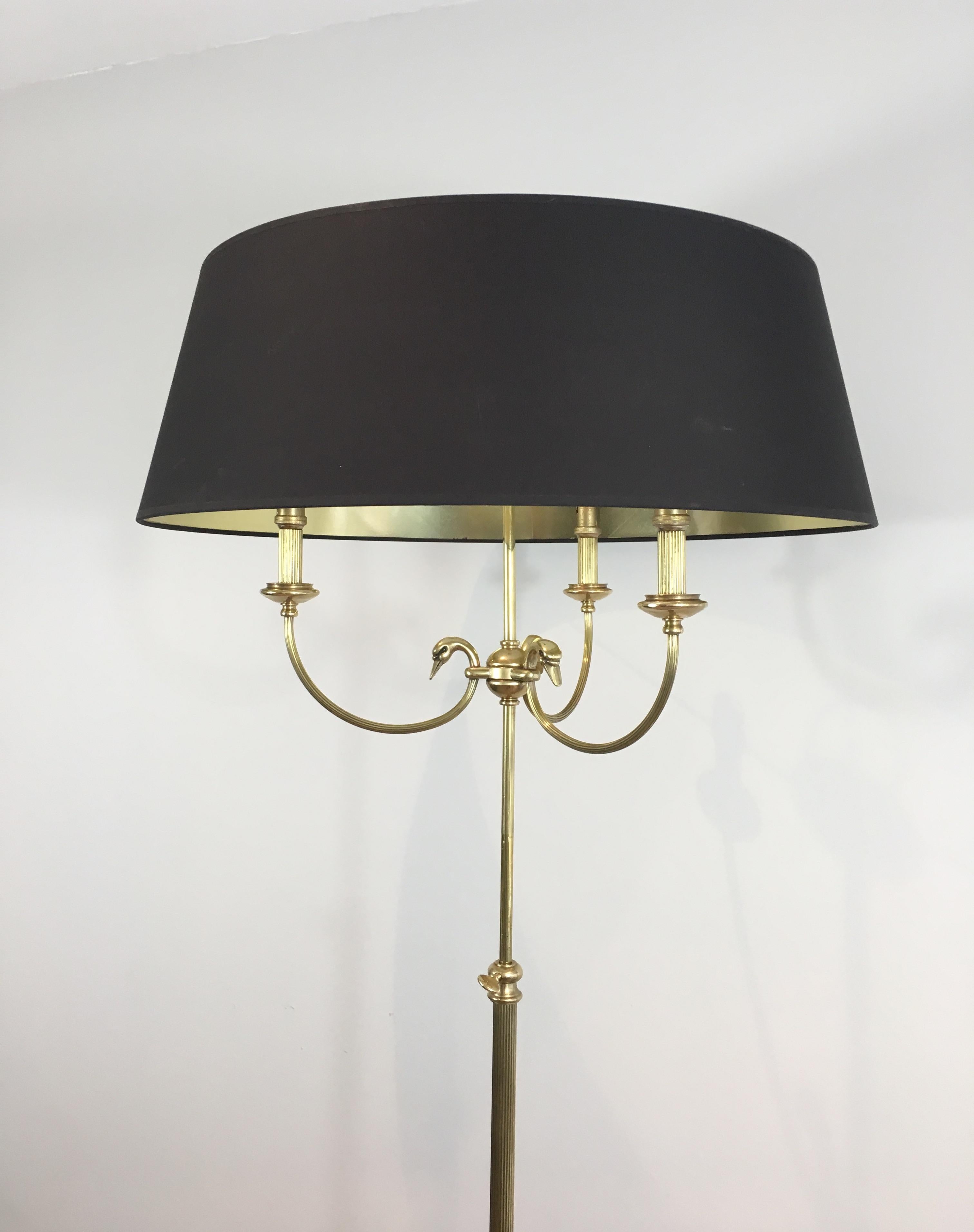 Very elegant neoclassical brass adjustable floor lamp with swanheads. This is a very fine work by famous French designer Maison Jansen, circa 1940.
   