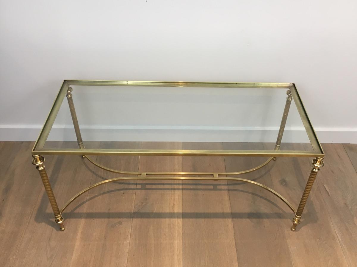 Attributed to Maison Jansen. Neoclassical brass coffee table with glass top, French, circa 1940.