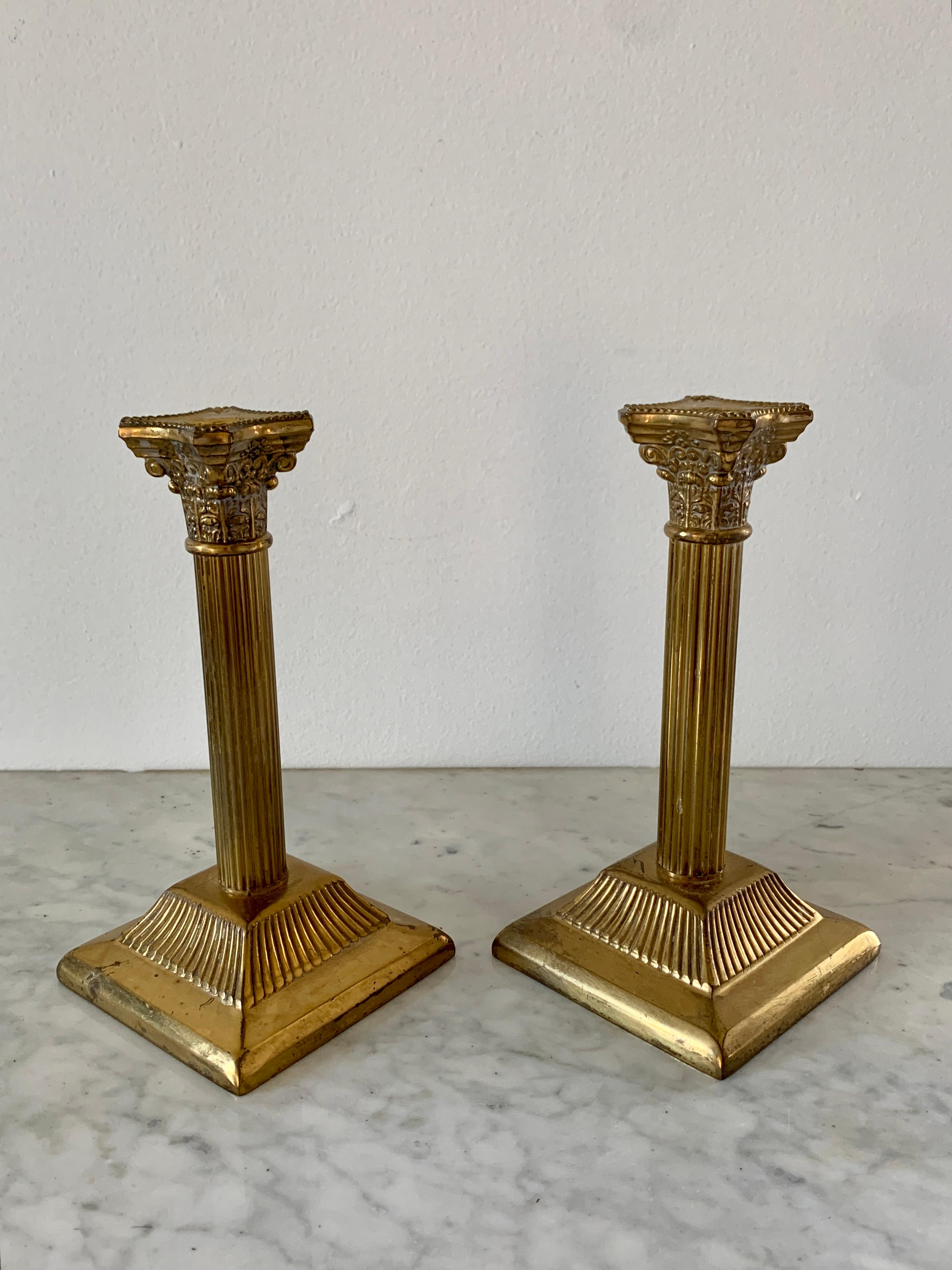 A gorgeous pair of Neoclassical style brass corinthian column candle holders

Circa Mid-20th Century

Measures: 4.25