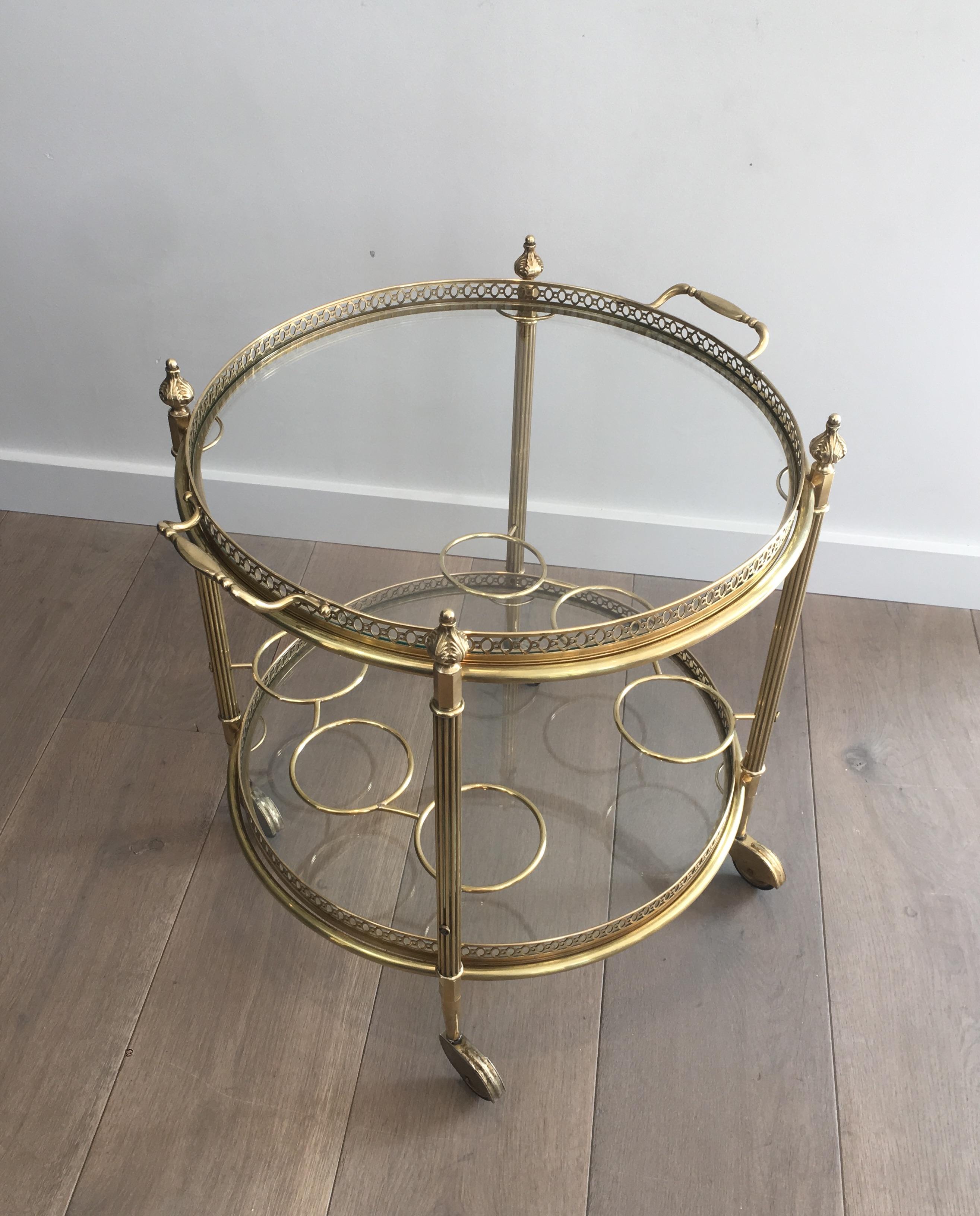 This very nice neoclassical style bar cart is made of brass, Top tray is removable and can be used as a tray to serve. This is a French work attributed to Maison Jansen. Circa 1940.