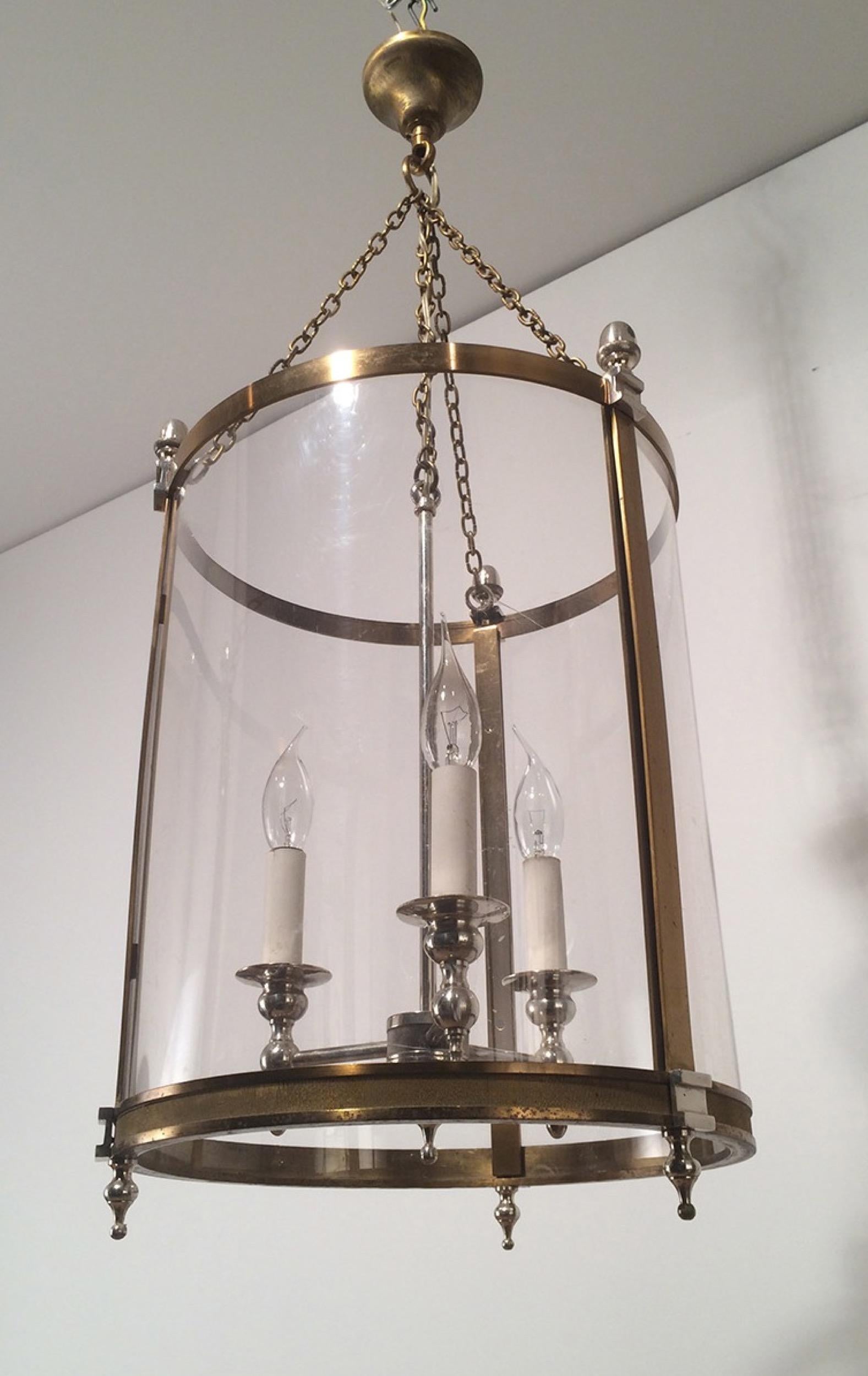 This neoclassical large lantern is made of brass and silver plated with strong plastic rounded faux-glass. This is a French work, in the style of famous Maison Jansen, circa 1970.