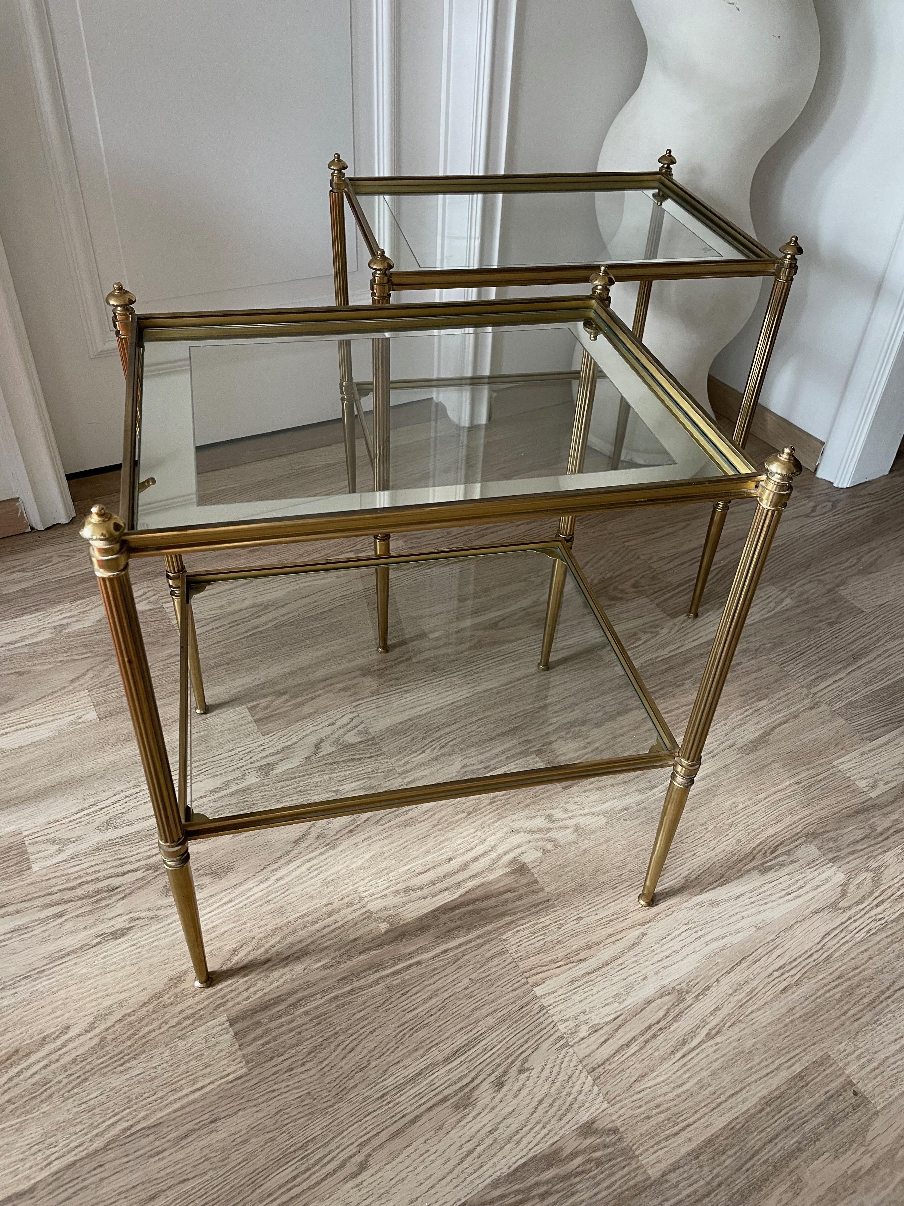 Elegant brass and mirrored glass tops side by side tables.
Neoclassical, two tiers and fine carving.
By maison Charles & Fils- Paris-France.
Circa 1970.
