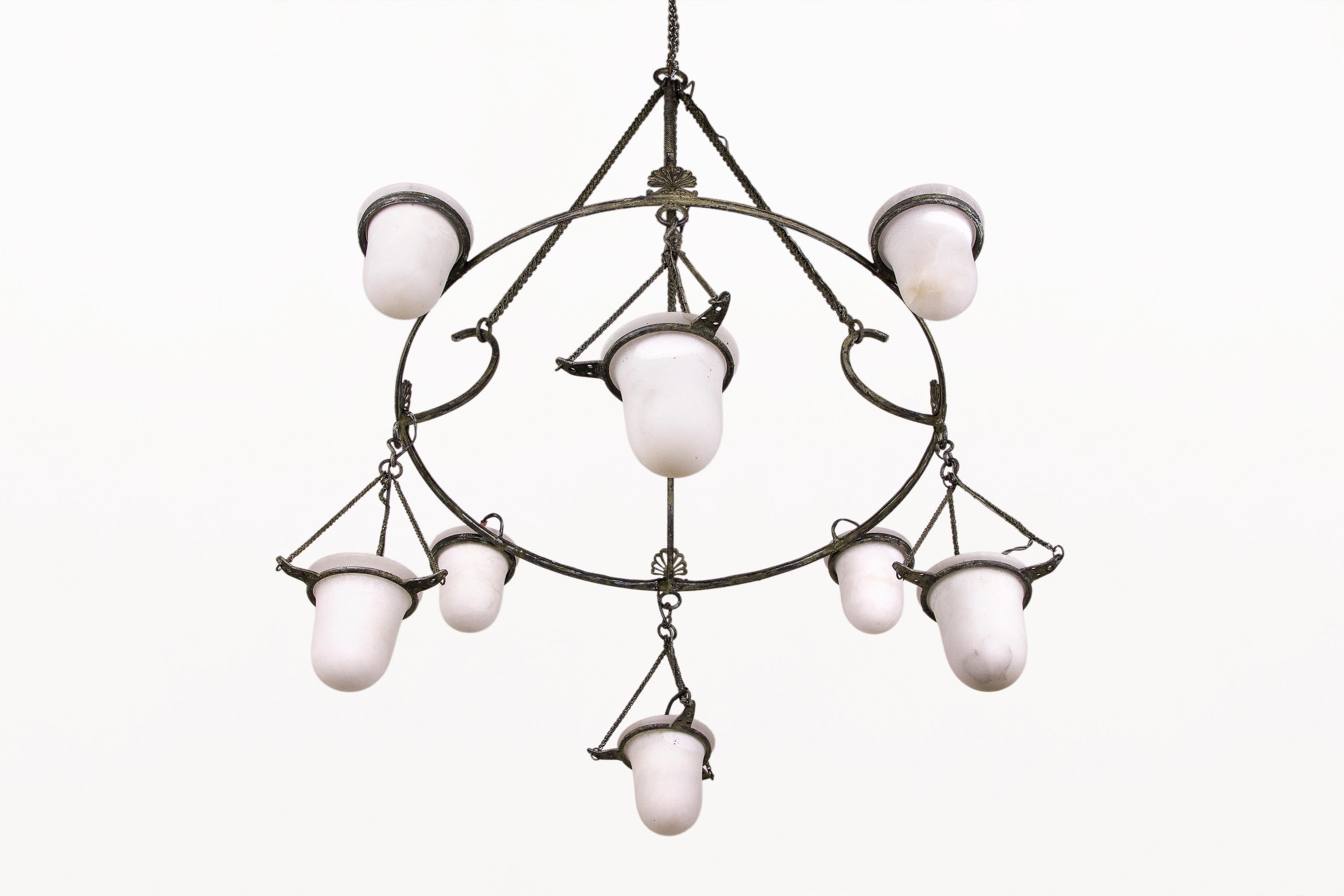 Neoclassical bronze chandelier.
Eight hanging alabaster cups, each electrified with an individual bulb.
Bronze structure in the style of a Greek Antiquities chandelier.
Circa 2000 France.
Good vintage condition.