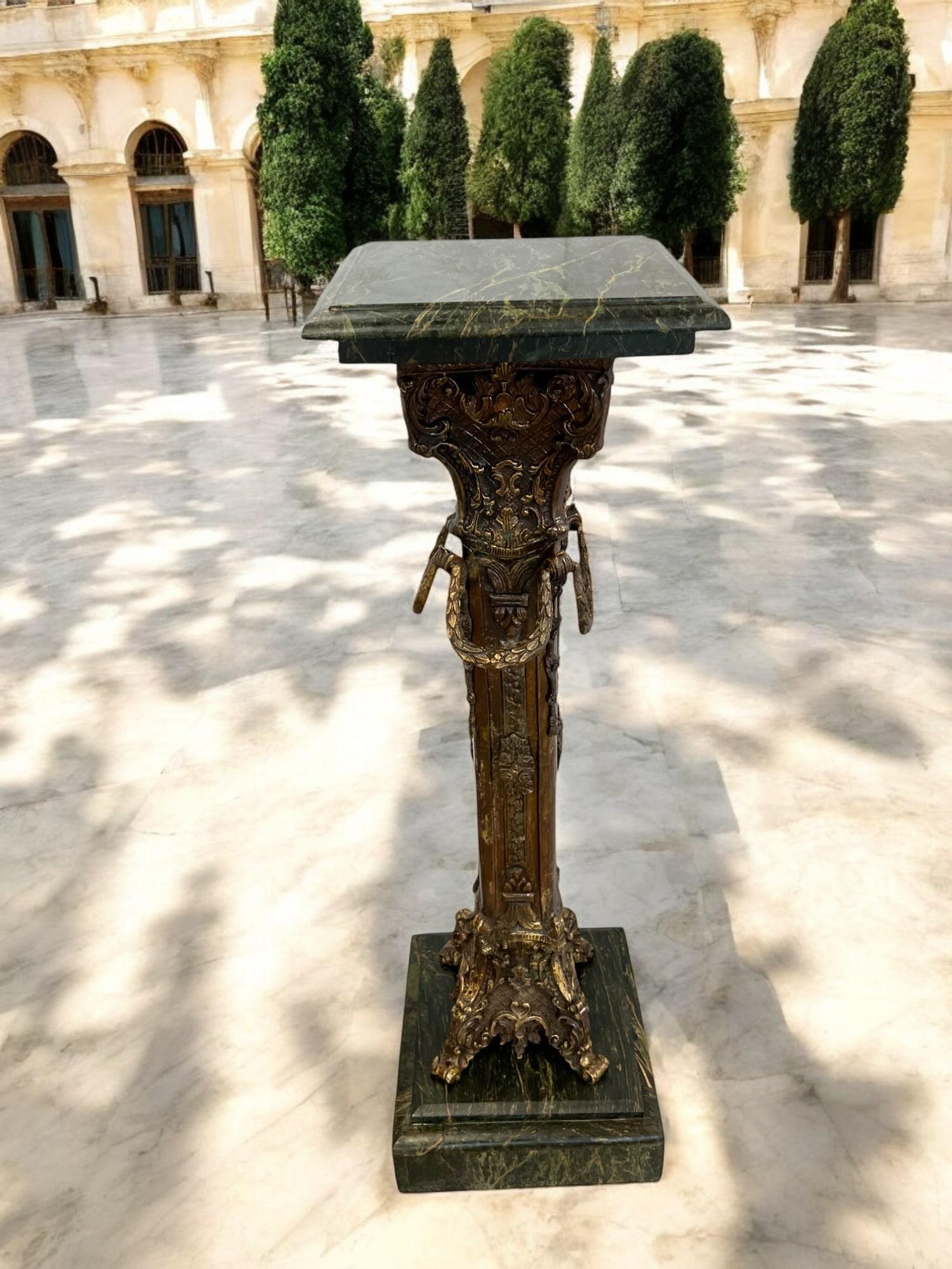 Ce piédestal impressionnant présente un mélange captivant de motifs Renaissance et classiques. Fabriquée en bronze, la colonne centrale présente des figures et des feuillages complexes, ajoutant de la profondeur et de l'intérêt visuel. Le piédestal