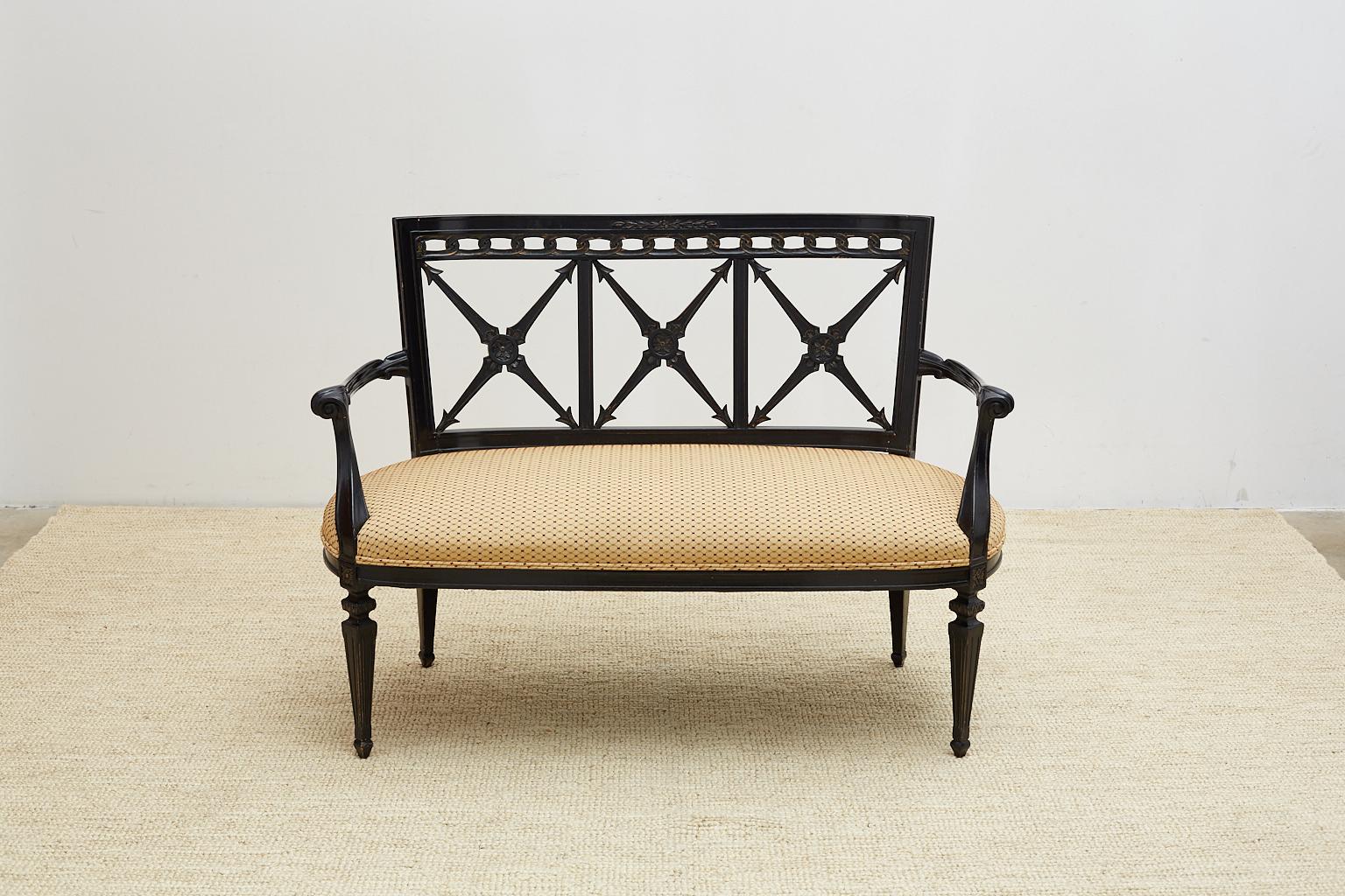 Dramatic carved black lacquer settee or bench in the neoclassical taste. Features a square back beautifully carved with neoclassical motifs rising above an oval seat with curved arms. The frame is supported by tapered legs that are reeded. The light