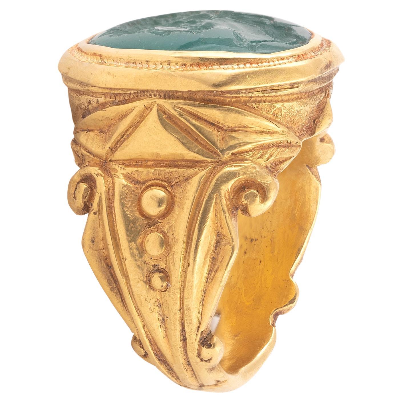 A Neoclassical carved emerald intaglio, depicting Roman Emperor Hadrian, the oval emerald 1.5cm high, mounted in a later gold ring, size 8 1/2