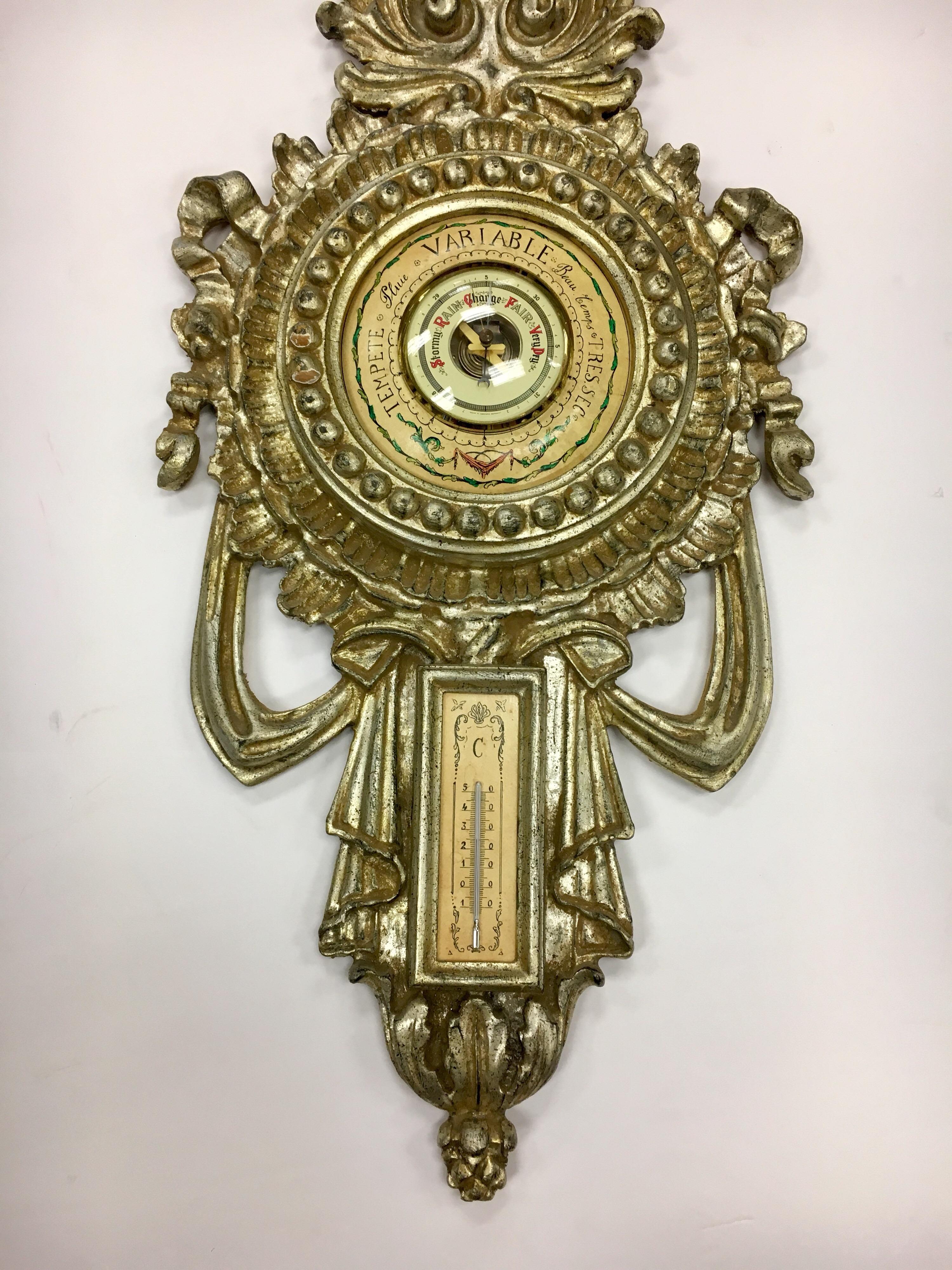 Giltwood carved Italian wall barometer and thermometer combination in the neoclassical style. For decorative use only as we are not sure if the barometer and thermometer work, circa 1950s and stamped made in Italy on back.