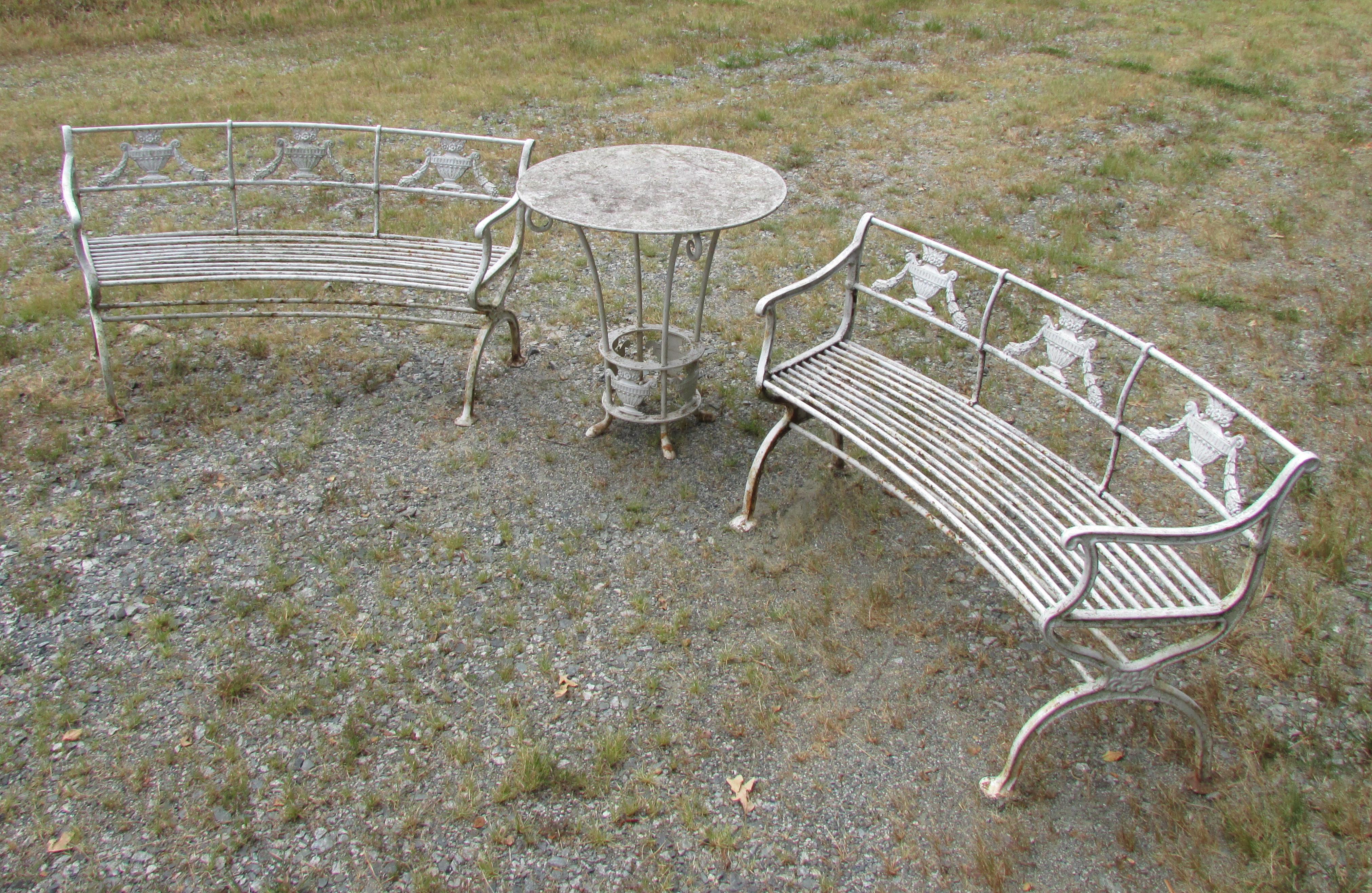 Pair old white painted curved cast iron benches in neoclassical style with a round center table (19 1/8