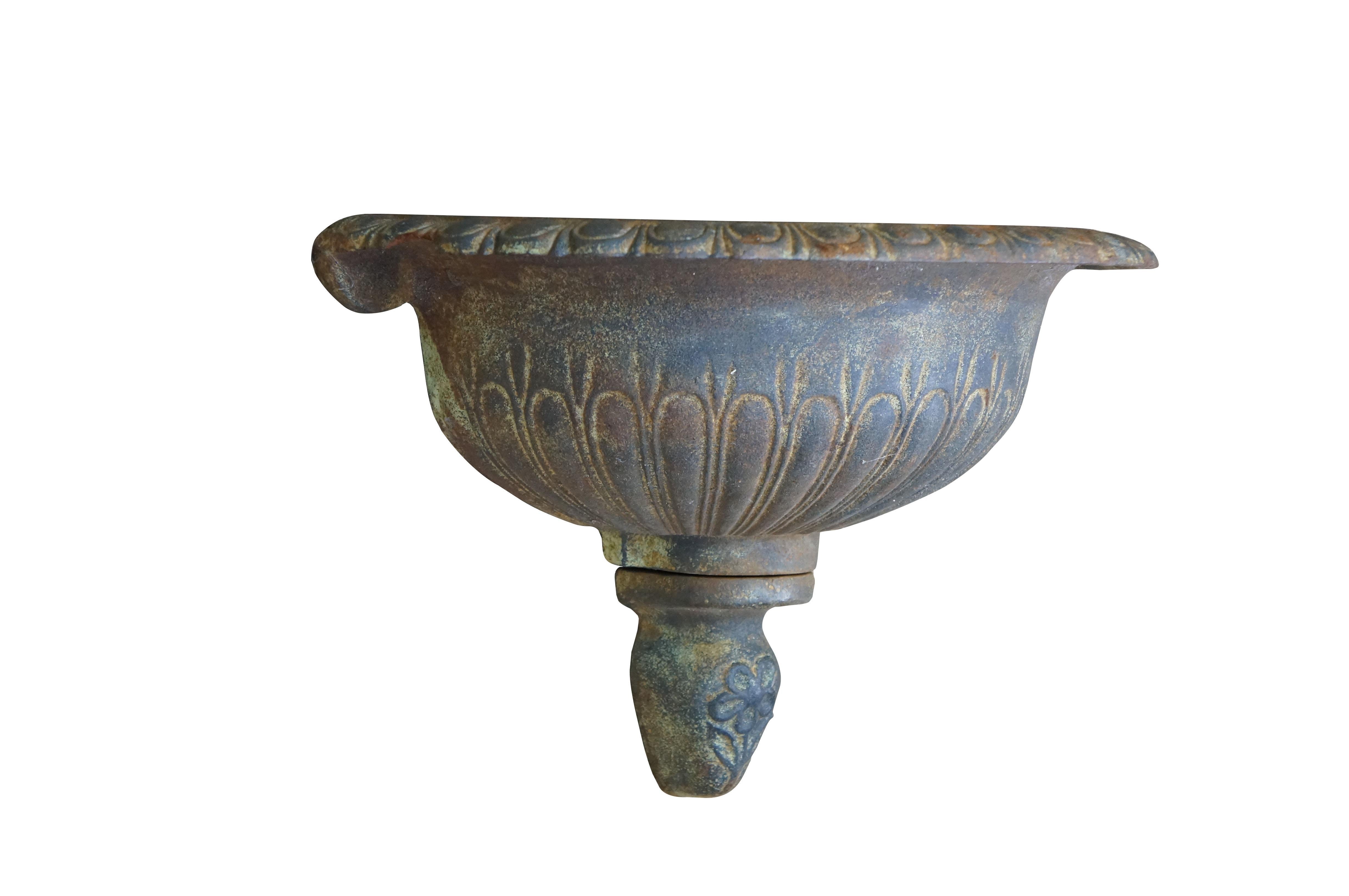 Vintage cast iron wall hanging fountain bowl / planter / garden urn. Demilune / half round shape with fluted Neoclassical styling and a flower on the drop finial.

Dimensions:
17.5