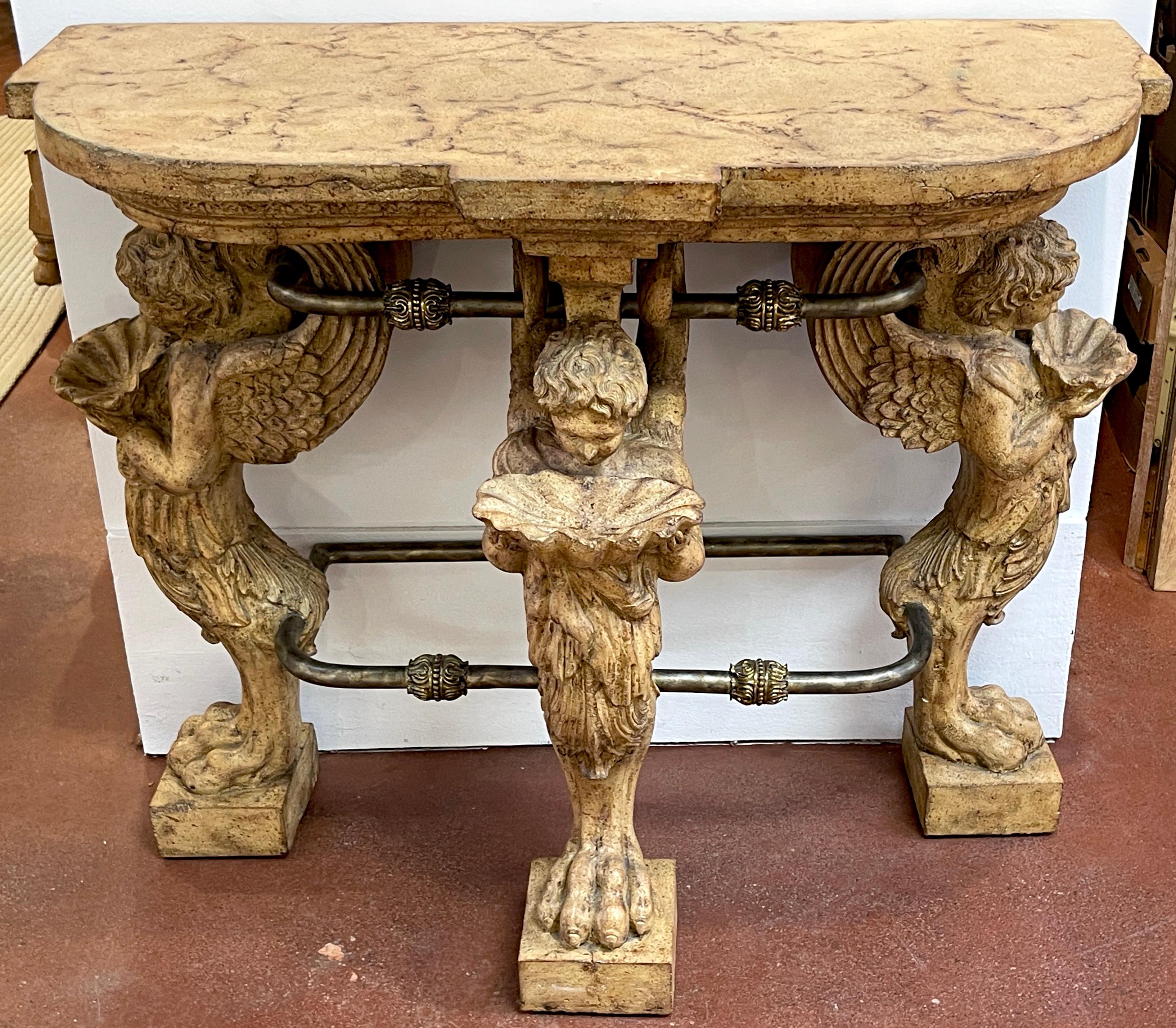 Neoclassical Cast Stone Iron & Brass  Angel Caryatid Console Table
Enhance your interior with the grandeur of this Neoclassical Cast Stone, Iron, and Brass Angel Caryatid Console Table, a masterwork  that exudes timeless elegance and