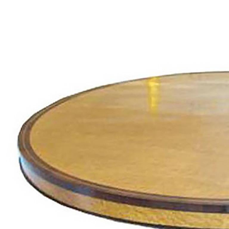 An Austrian Neoclassical Thuya wood, Kingwood and parcel-gilt center table. The circular banded top on a spreading standard, the circular base raised on three paw feet.