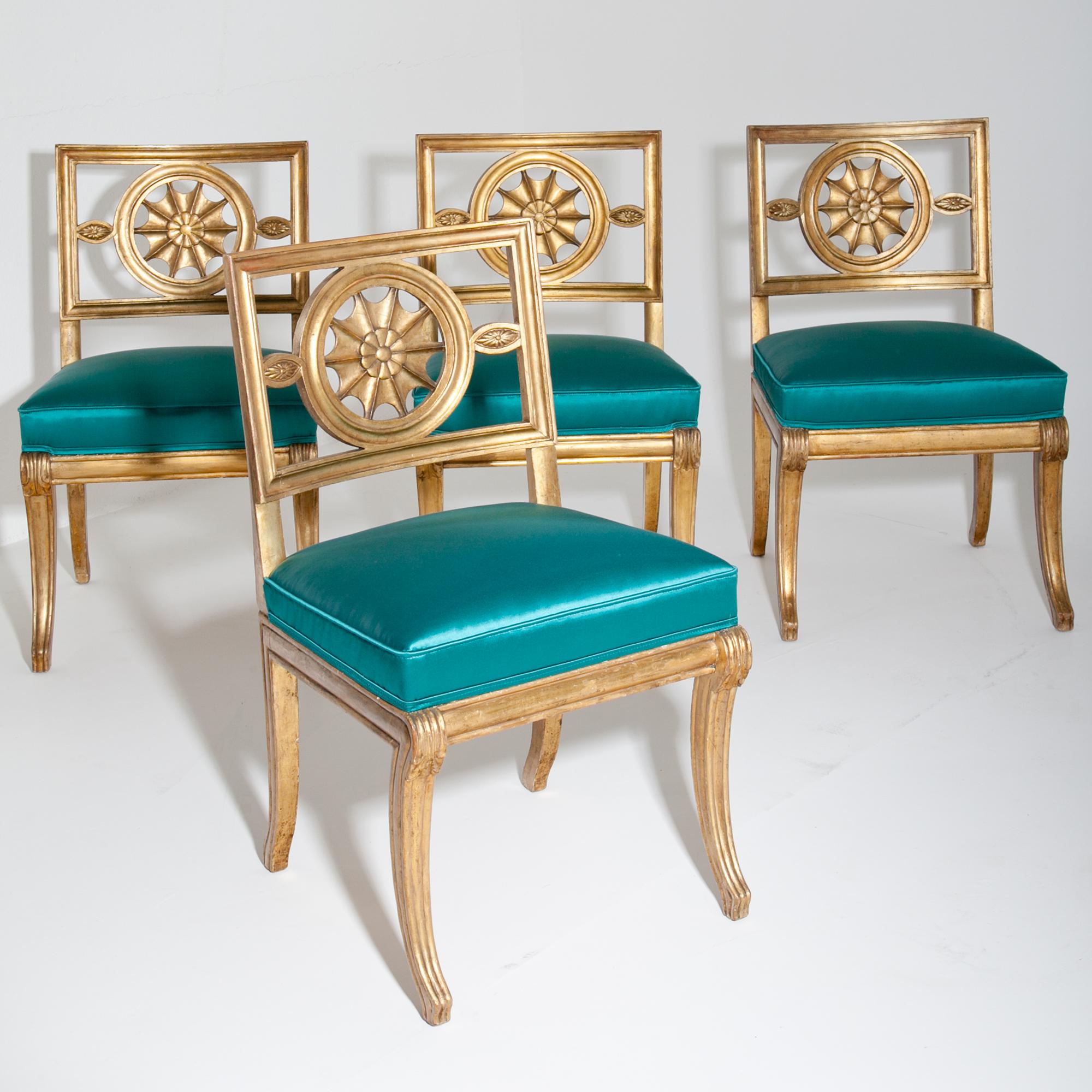 Four gilt chairs and one armchair with curved legs and backrests with a star shaped décor element. The chairs were reupholstered with a high-quality turquoise-blue fabric. The original chair was designed for Castle Wörlitz. 
Lit.: H. Schmitz: