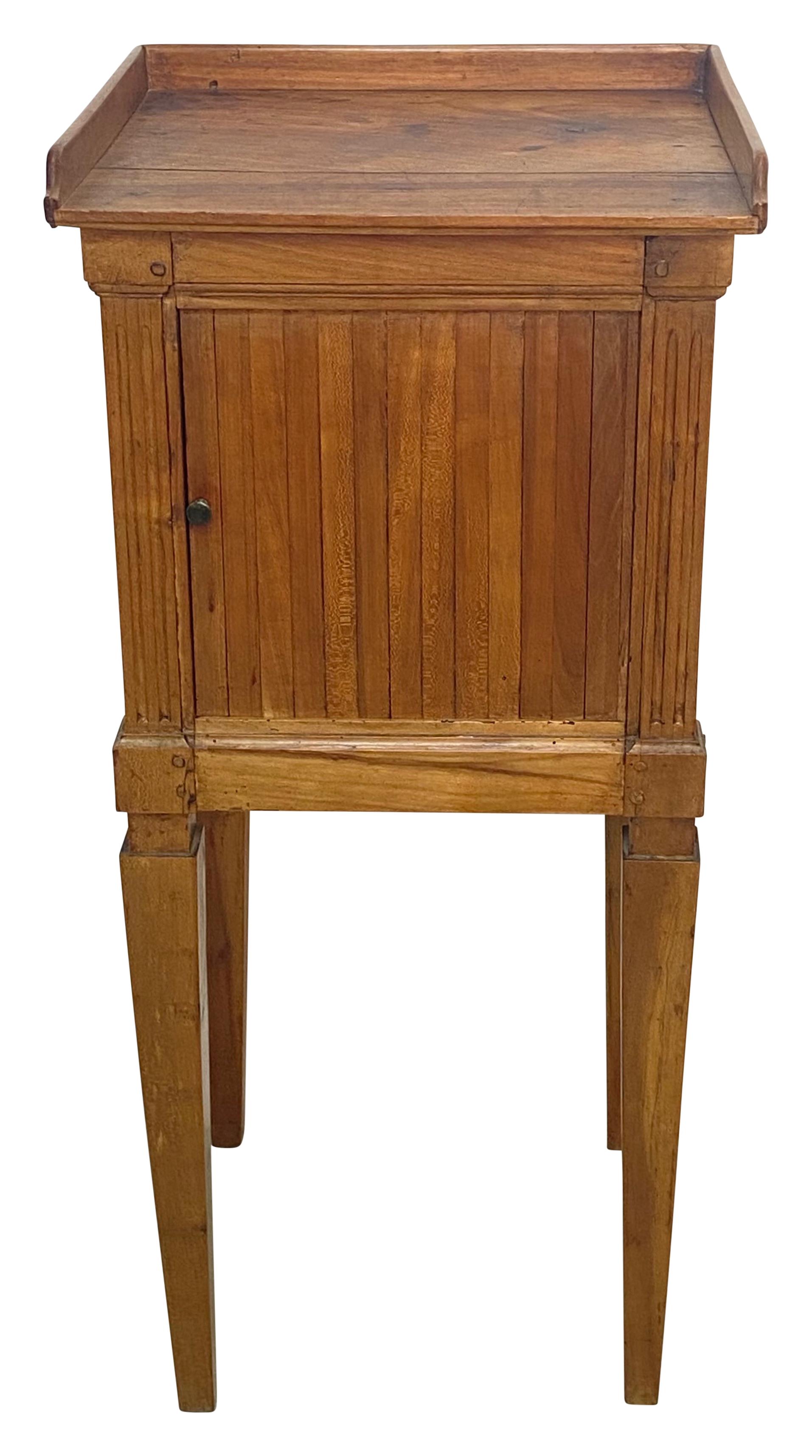 An attractive solid cherrywood bedside table cabinet with tambour sliding front door and standing on tapering square legs. The tambour door slides very smoothly.
French, late 18th century circa 1780.
In remarkable original antique condition. Sturdy,