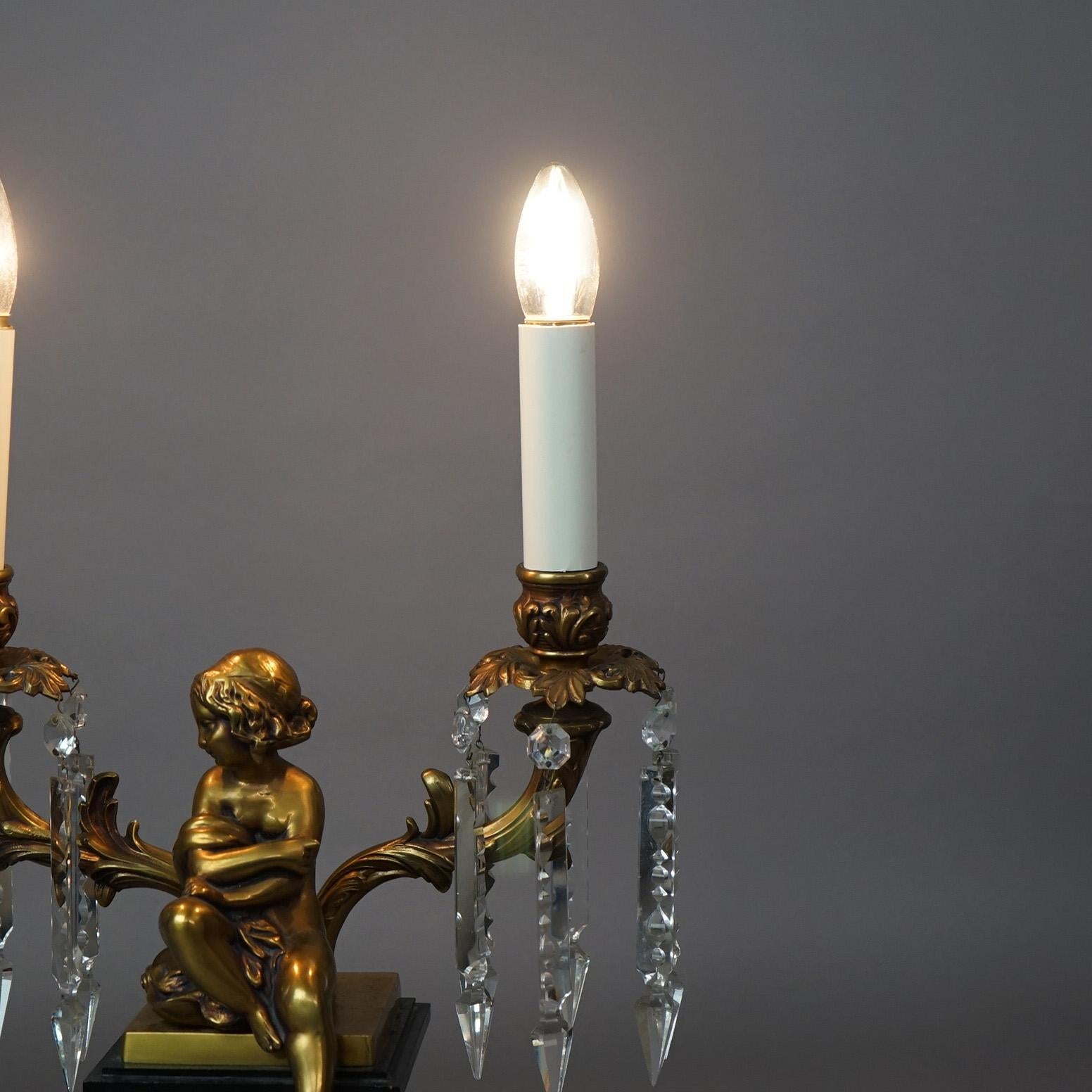 20th Century  Neoclassical Cherub Figural Two-Arm Brass & Ebonized Metal Table Lamp 20thC For Sale