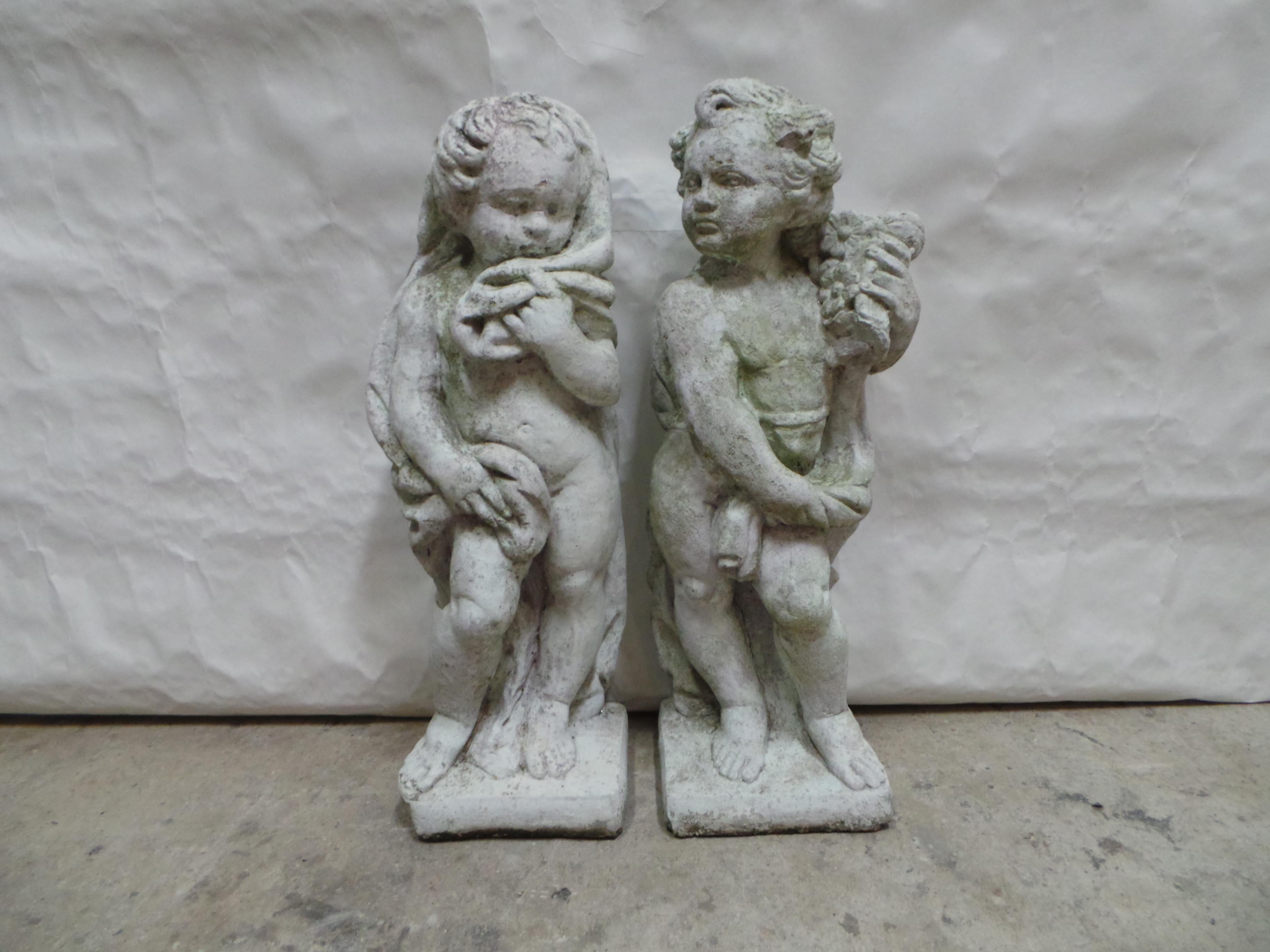 This is a unique set of 2 Neoclassical Cherub or Putto Cast Stone Garden Statues.