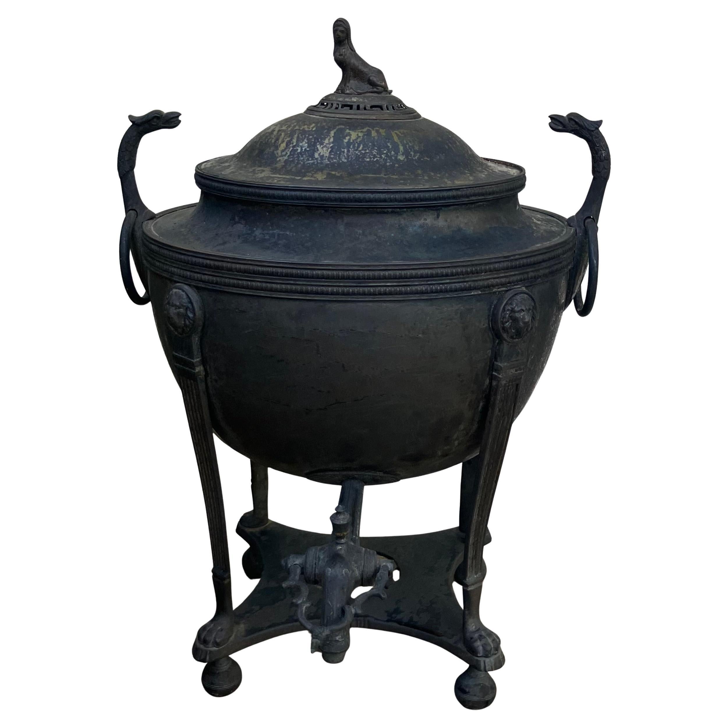 Neoclassical Coffee Samovar Urn. Antique English dark patinated metal urn-form samovar for tea or coffee in the neoclassical taste featuring a classic urn form body with a sphinx knop lid, griffin headed and ringed handles above deep reservoir basin