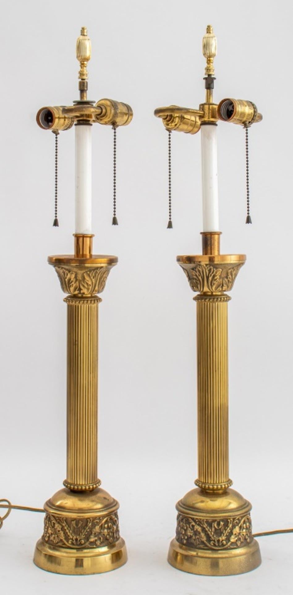 Pair of Neoclassical chased brass lamps, Corinthian column shape with vine and ears of wheat motif to base. Measures: Each: 29.5