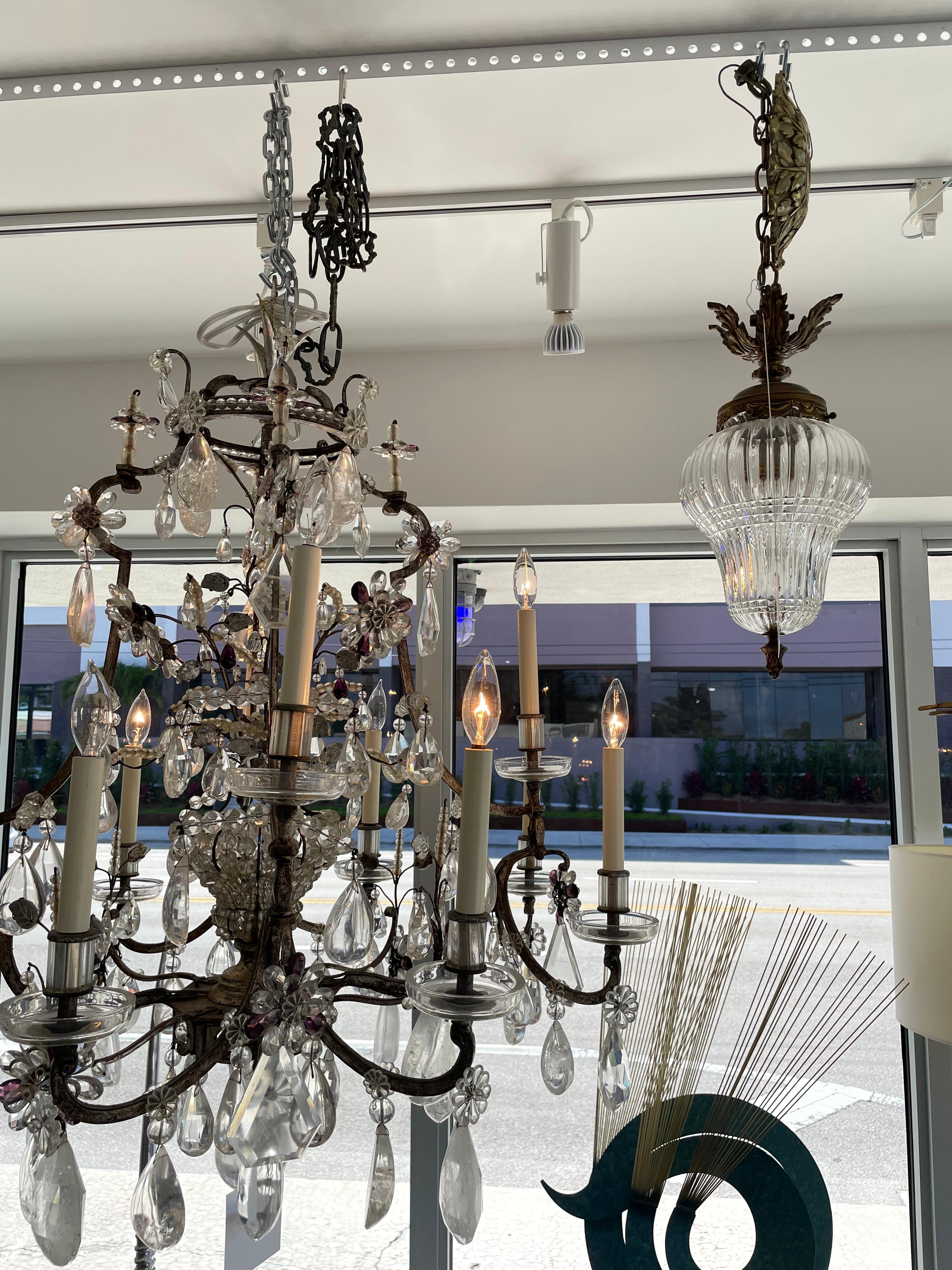 This stylish and chic pear-shaped chandelier was acquired from a Palm Beach estate and is the perfect size for a foyer, powder room or perhaps dressing closet.

The bronze casting have aged to a beautiful patina, and the handcut crystal globe
