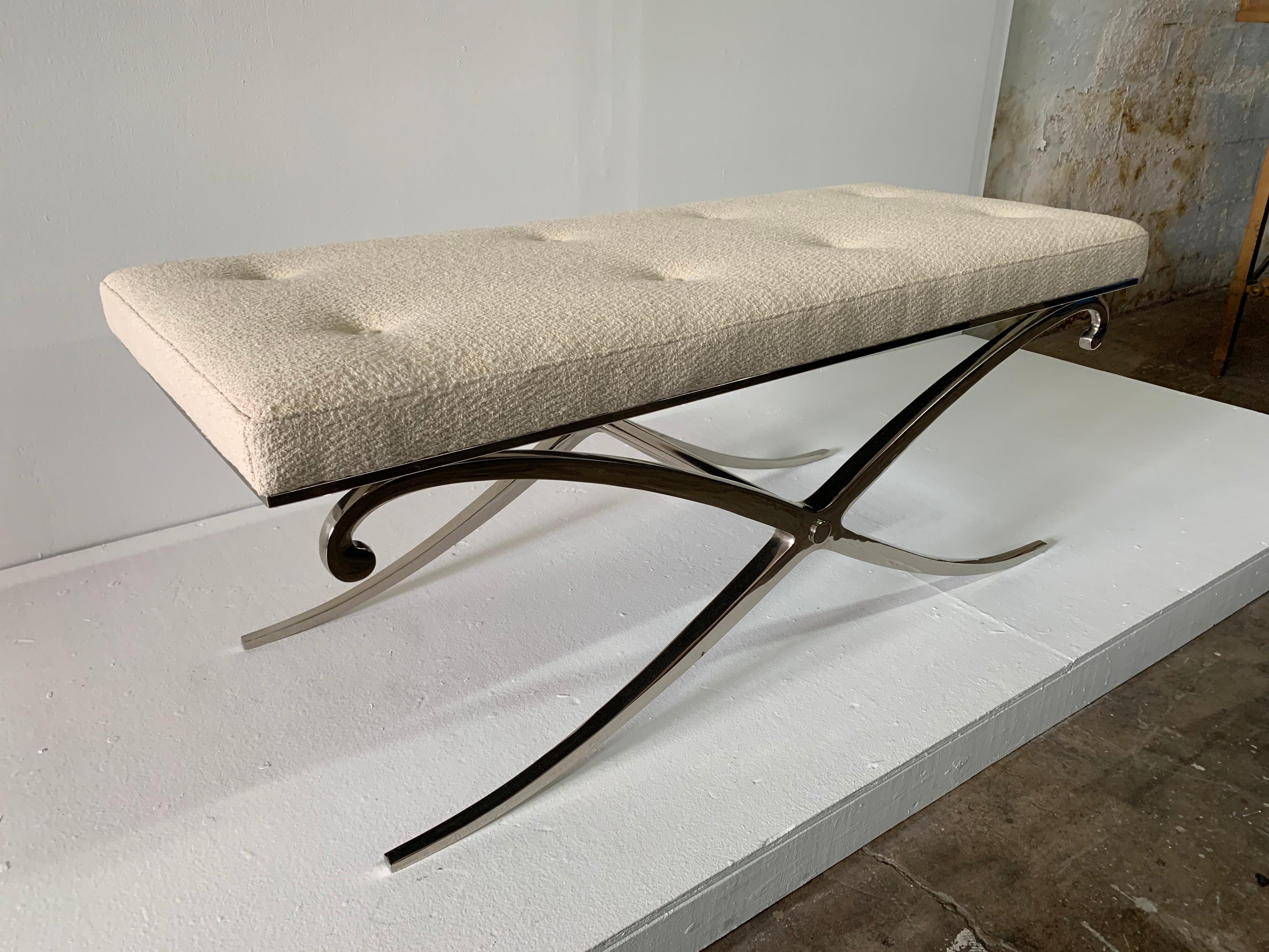 This heavy and important elegant X base in polished steel framed long bench is reupholstered in a luxurious off-white bouclé fabric. This is ready to place in your space.