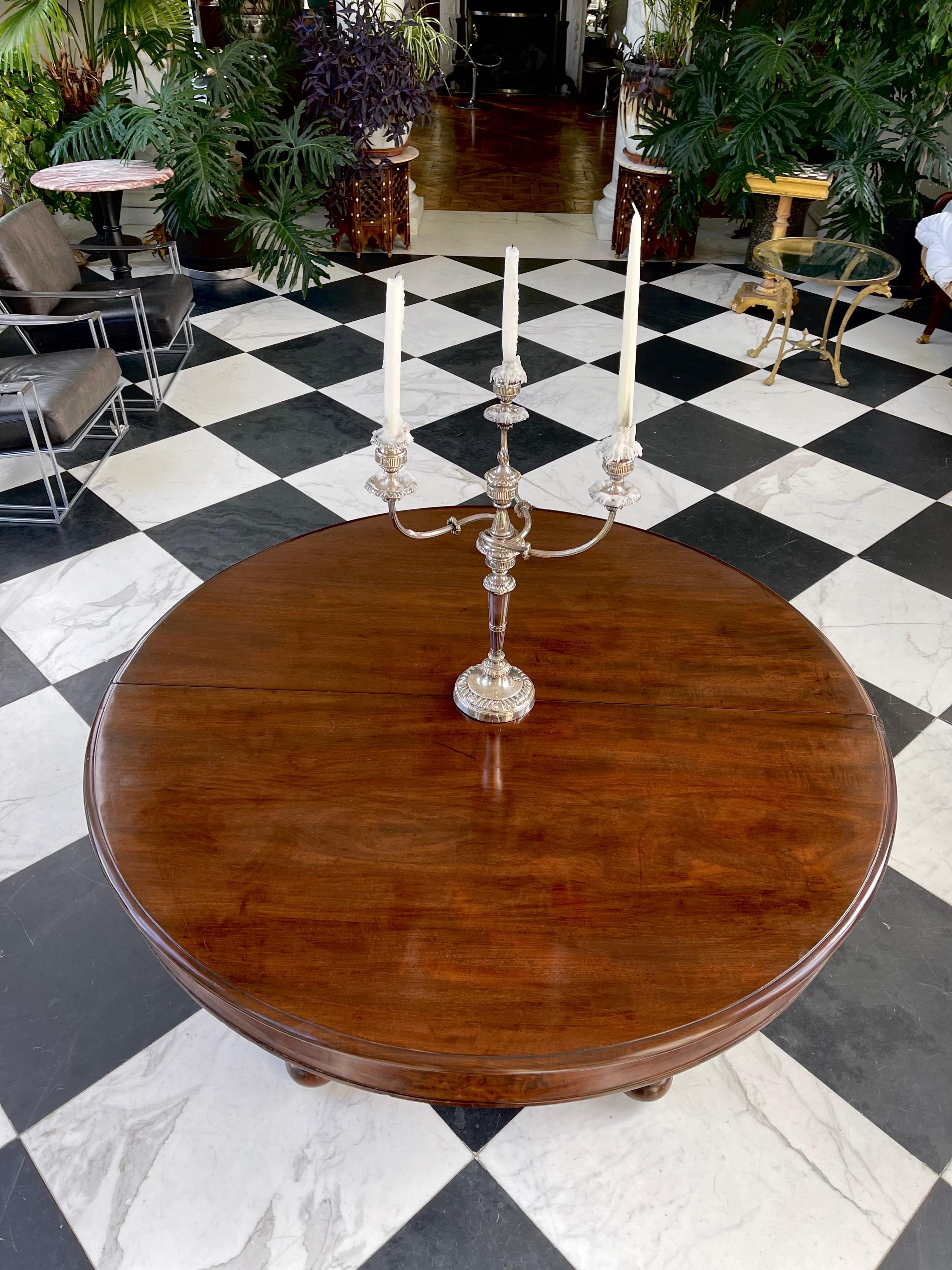 Built to last this 58” round American Federal Cuban mahogany extension Banquet table will seat 18 comfortably. 
Everything about this table is original including hardware. The round table makes a great Center table. It has a bold tapered columnar