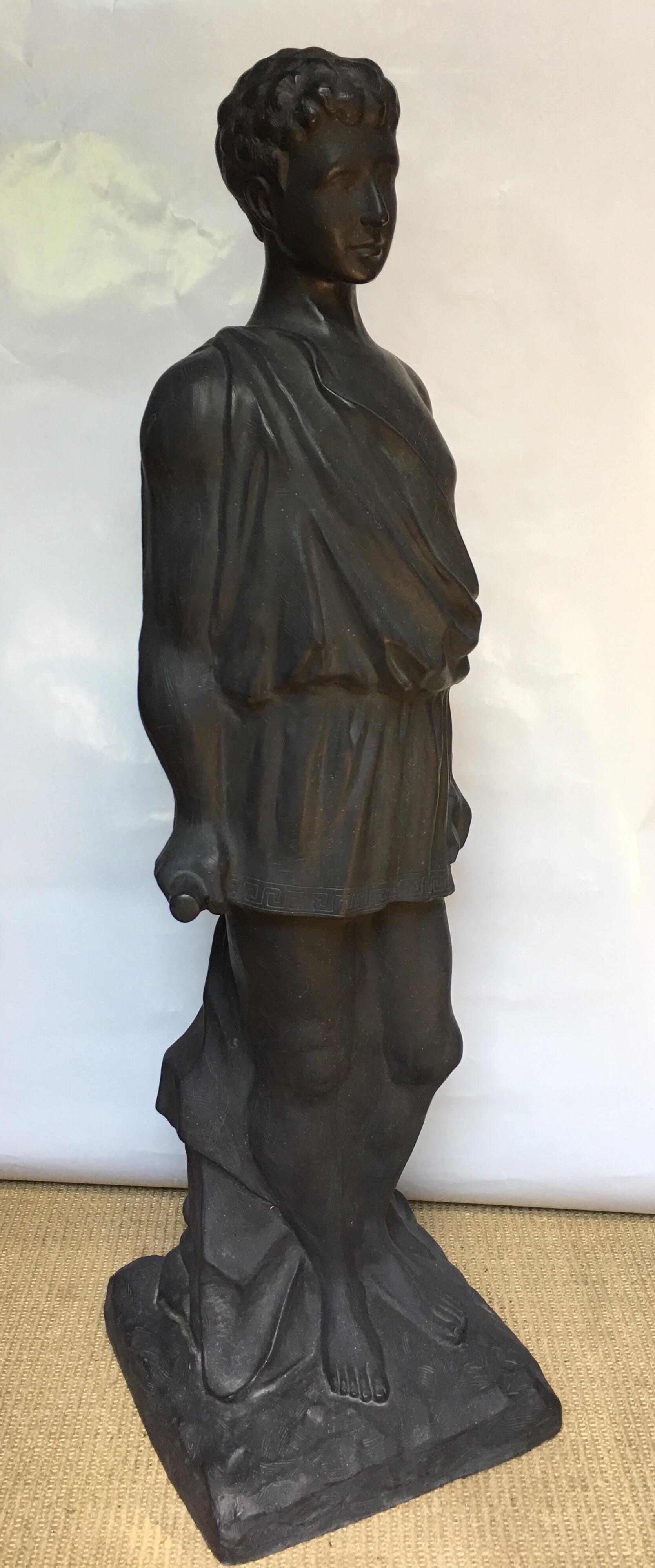 Large Roman style male statue featuring a draped cloth, Greek key motif, and a column pillar fragment. Suitable for indoor or outdoor display in the garden.  