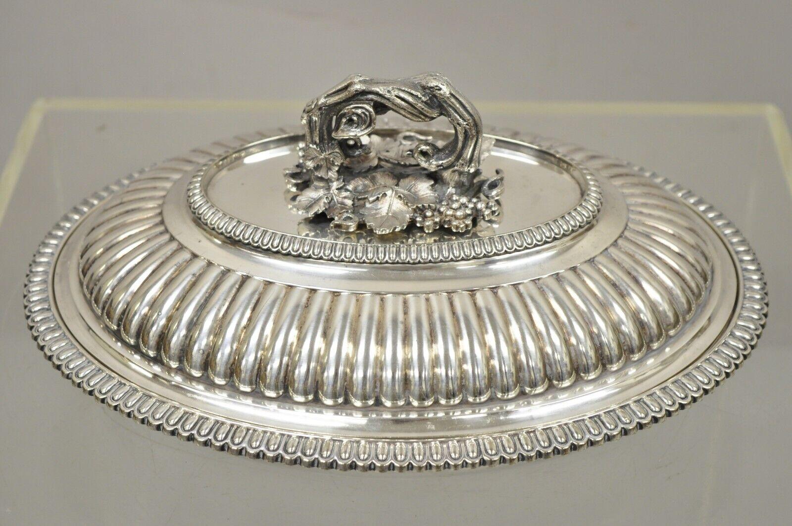 Antique English Neoclassical Style Elkington & Co Covered serving dish with Branch Grapevine Handle. Item features an extremely impressive removable branch and grapevine handle, ribbed dome, oval shape, very nice antique item. Circa Early 1900s.