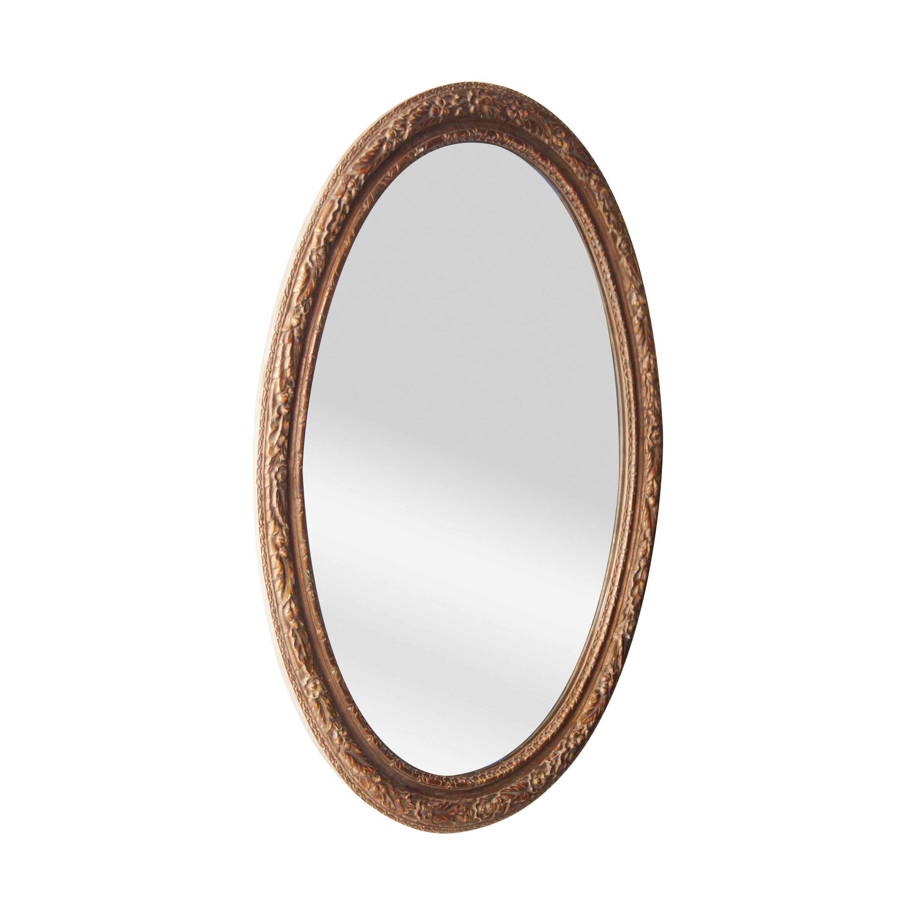 Neoclassical Empire oval handcrafted mirror. Oval hand carved wooden structure with gold foil finished, Spain, 1970.