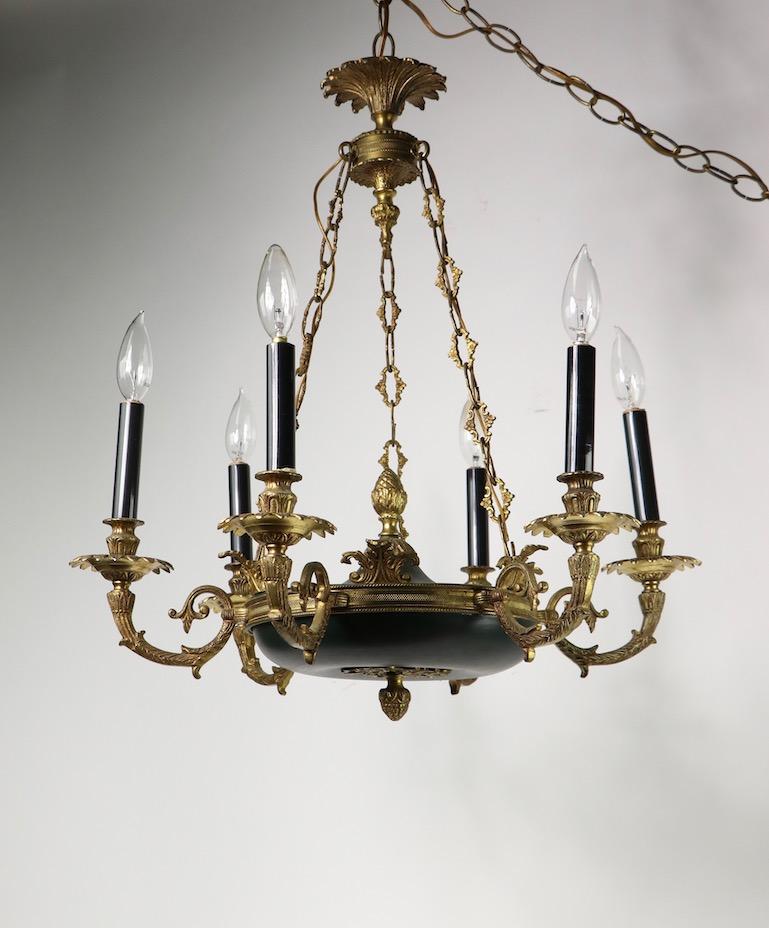 Empire Revival hanging chandelier having six cast brass arms, and a black center body, all suspended from four lengths of decorative chain. Very good, original and working condition, clean and ready to install, comes with extra long chain as this