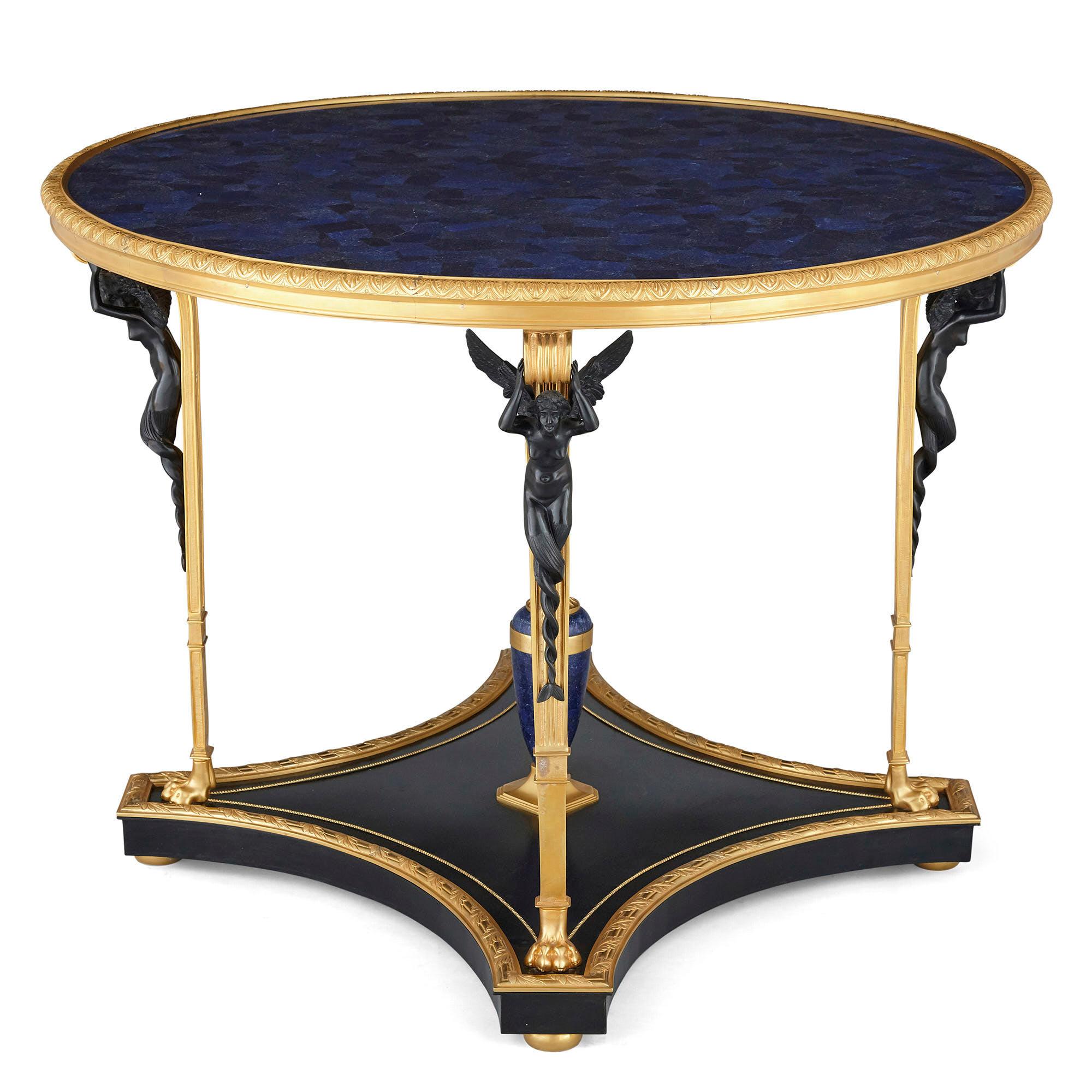 Neoclassical Empire style ormolu and lapis lazuli table with patinated bronze mounts,
French, 20th century
Dimensions: Height 74cm, diameter 100cm

Finely wrought in the French Neoclassical Empire style, this centre table features a lustrous