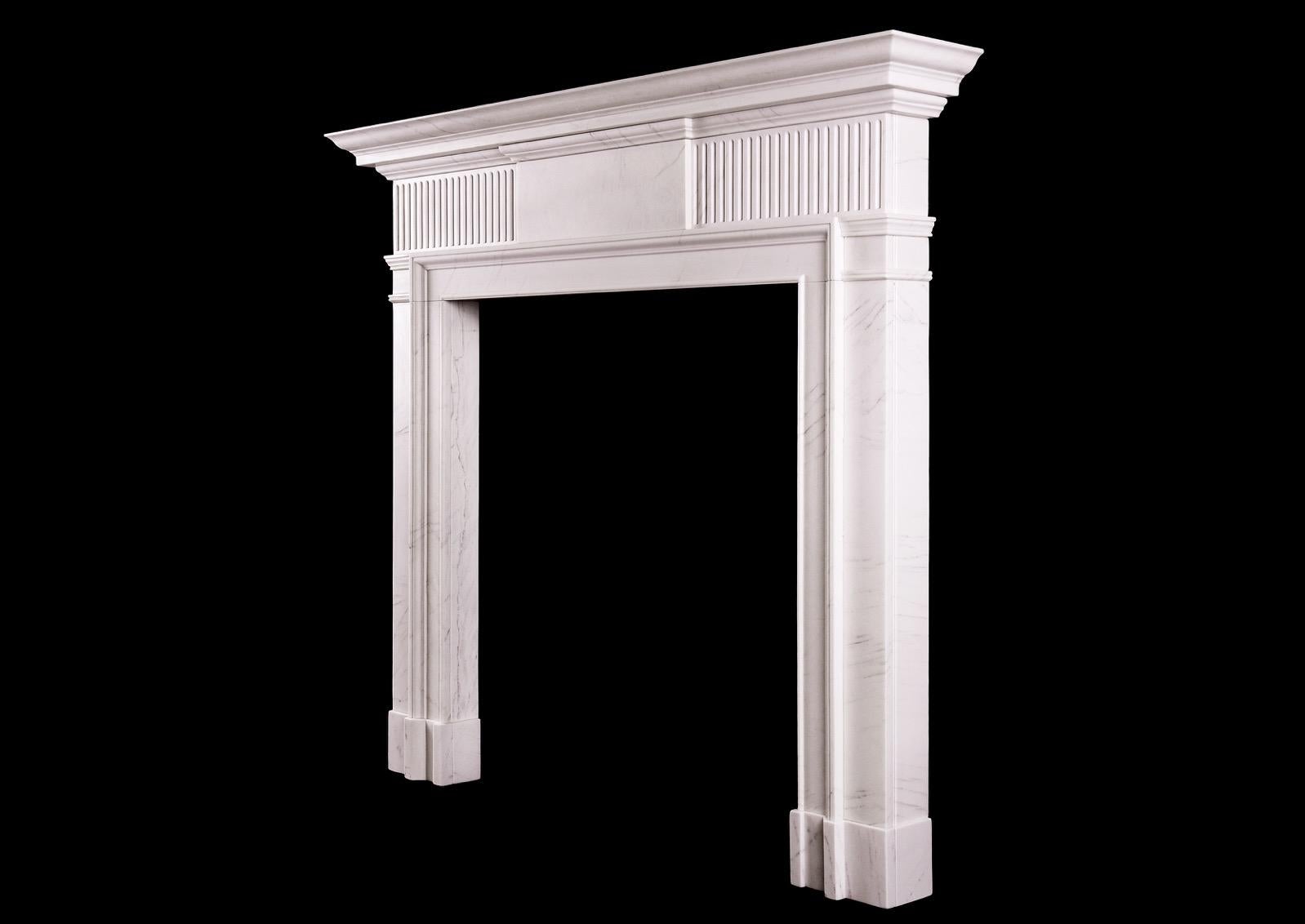 A simple neoclassical English fireplace in veined white marble. The moulded jambs surmounted by fluted frieze and plain centre blocking. Moulded shelf above.

Measurements: 
Shelf width: 1510 mm / 59 1/2 in
Overall height: 1290 mm / 50 3/4