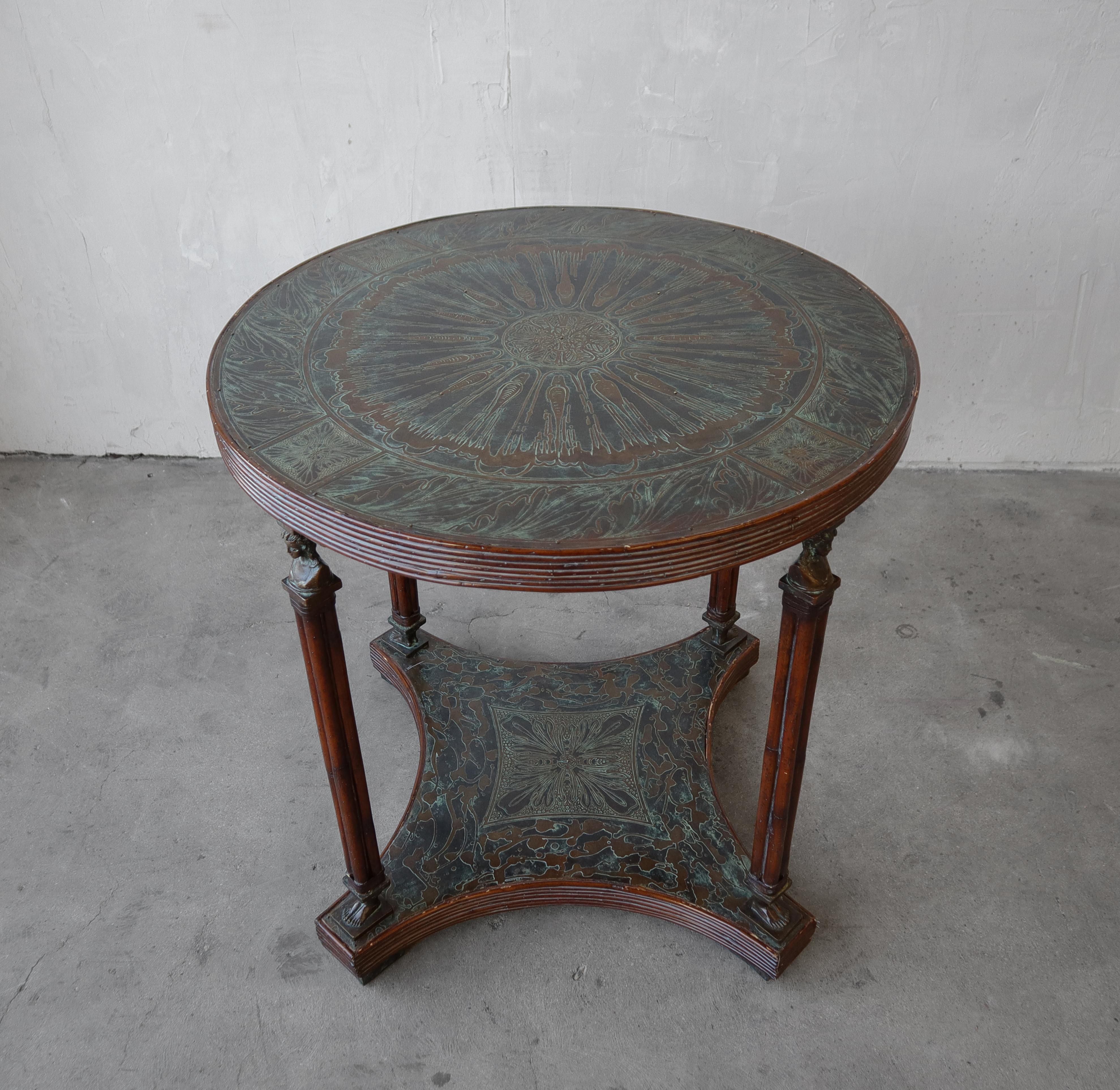 Absolutely gorgeous, perfectly patinaed, etched bronze and reed occasional table. The table is a nice size, It would be perfect with 2 chairs or as a small center table in an entry. The etching details, combined with the art nouveau heads and feet