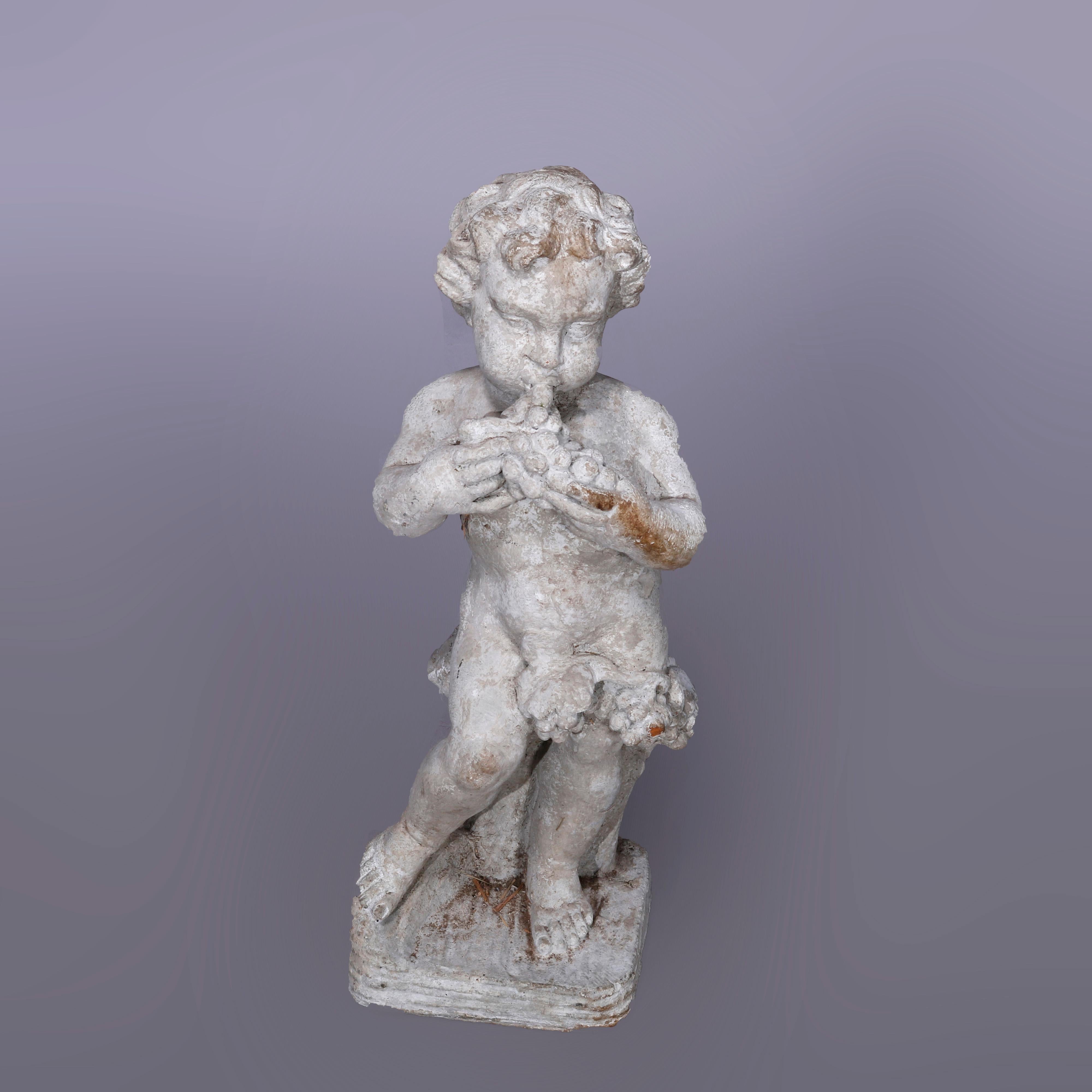 A neoclassical figural garden sculpture offers cast hard stone statue of cherub with grapes in countryside setting, 20th century

Measures - 24''H x 8''W x 8''D.