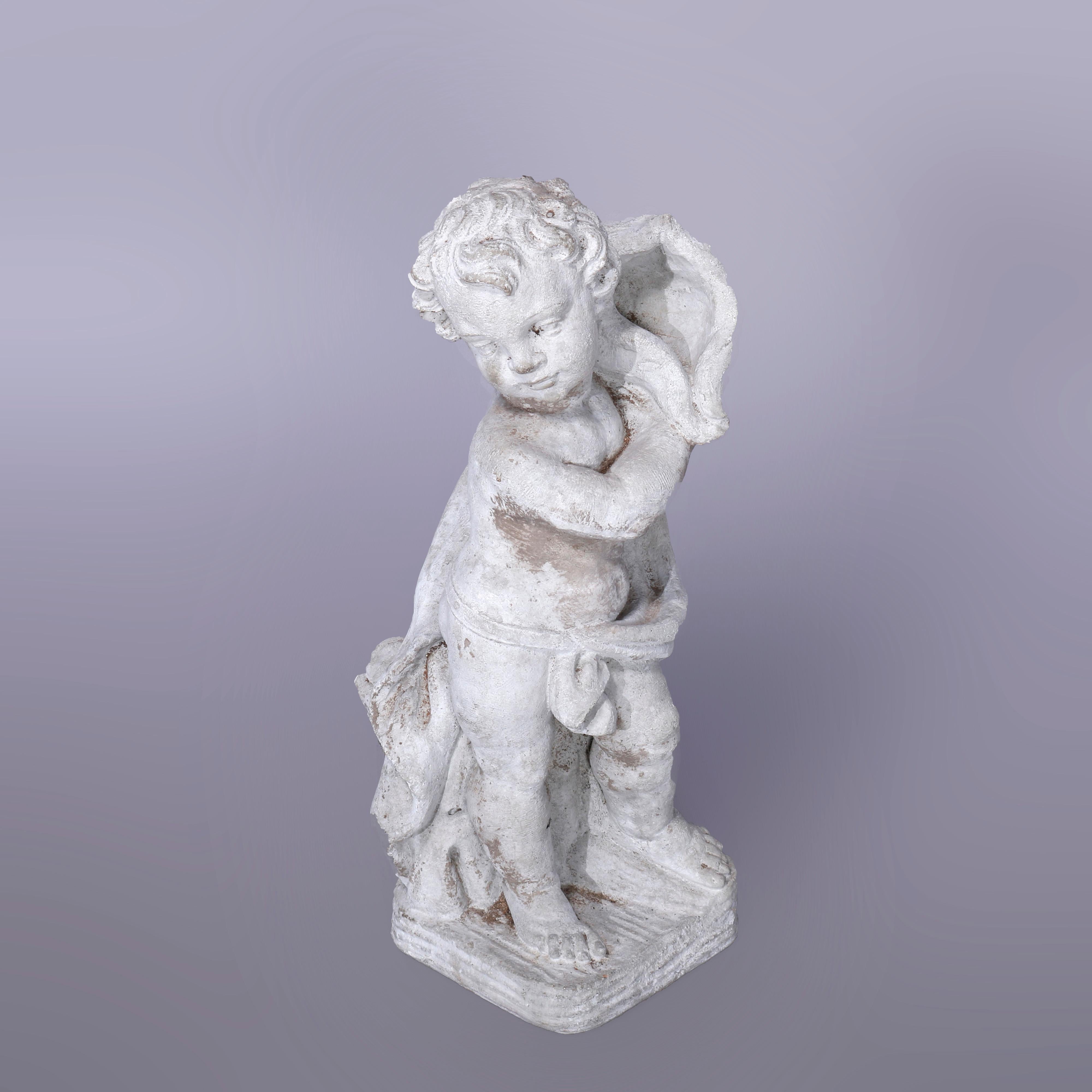 A neoclassical figural garden sculpture offers cast hard stone statue of cherub with seashell in countryside setting, 20th century

Measures - 23.5''H x 8''W x 8''D.