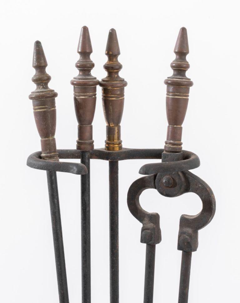 Neoclassical Fireplace Tool Set, comprising: a pair of tongs, a log poker, a shovel, and a stand, each with brass urn finial. Provenance: From a Kew Gardens Estate.