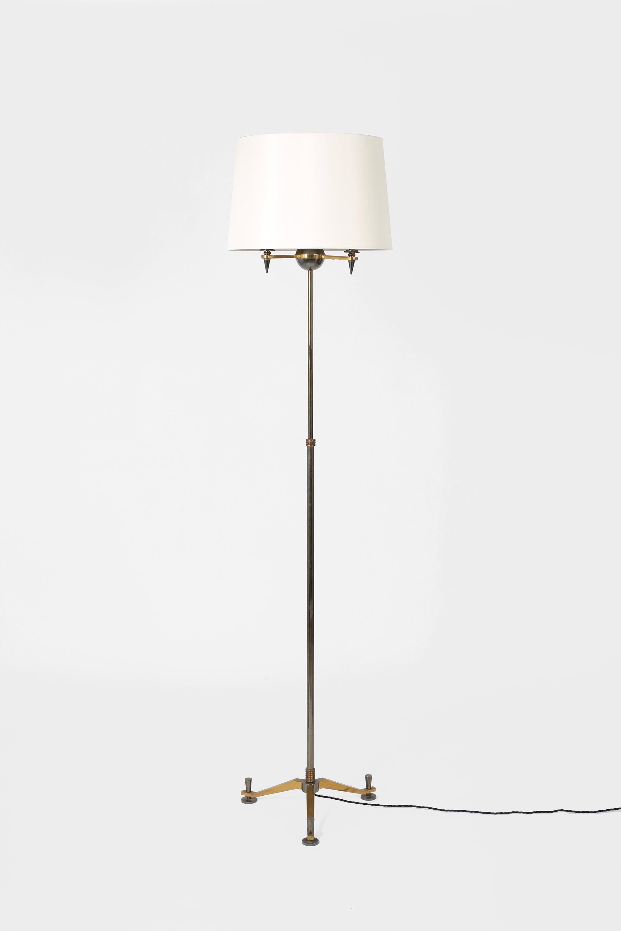 A chic neoclassical floor lamp in bronze and gunmetal by Henri Petitot for Atelier Petitot. French, c. 1930s. Supplied with an off white dupion silk shade.