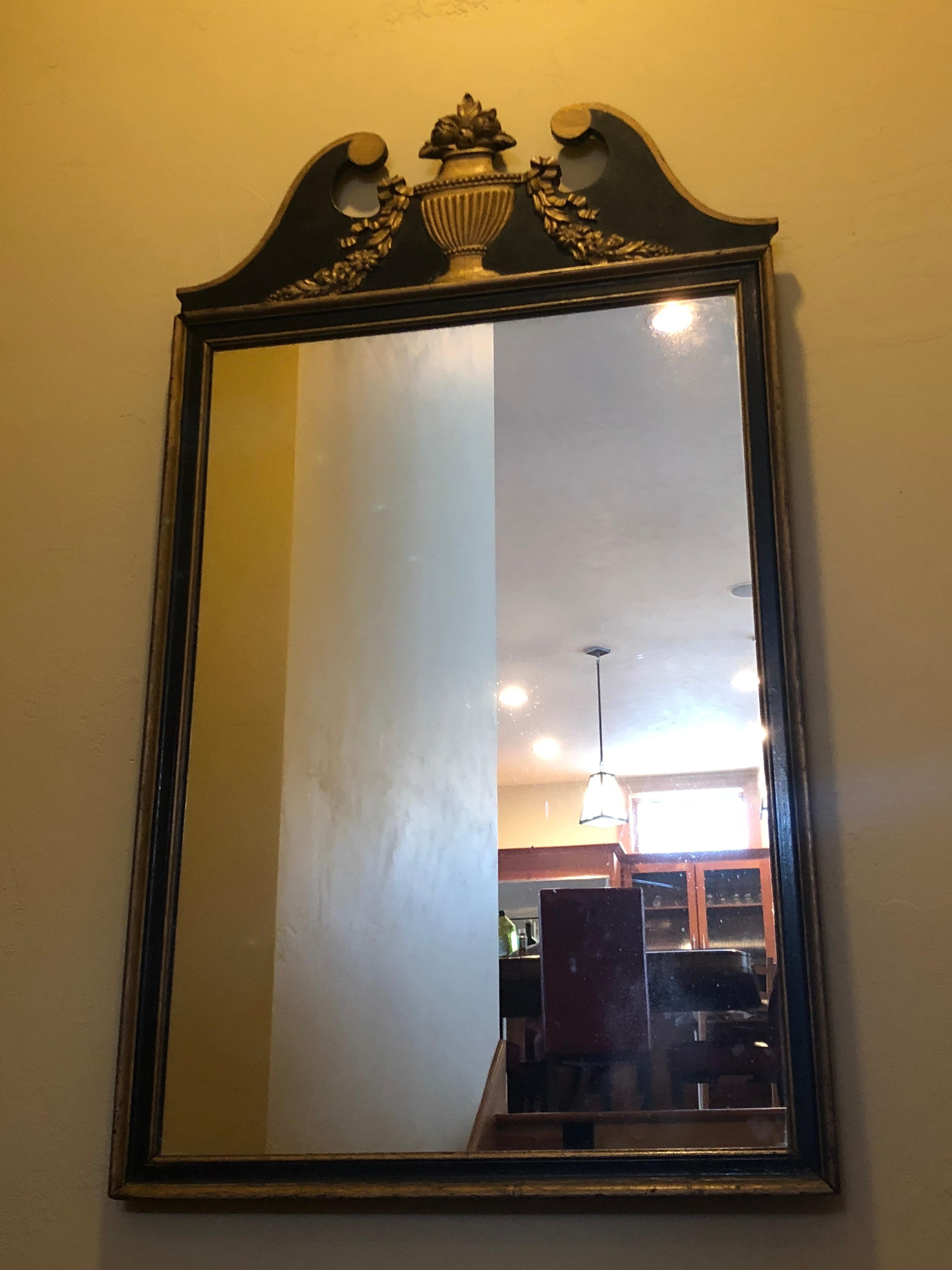 Lovely black and gilt neoclassical mirror. The paint and the mirror are original and have not been retouched. For a hallway or in an elegant gentleman’s dressing quarters the black and gilt are dramatic and understated. The condition of the paint is