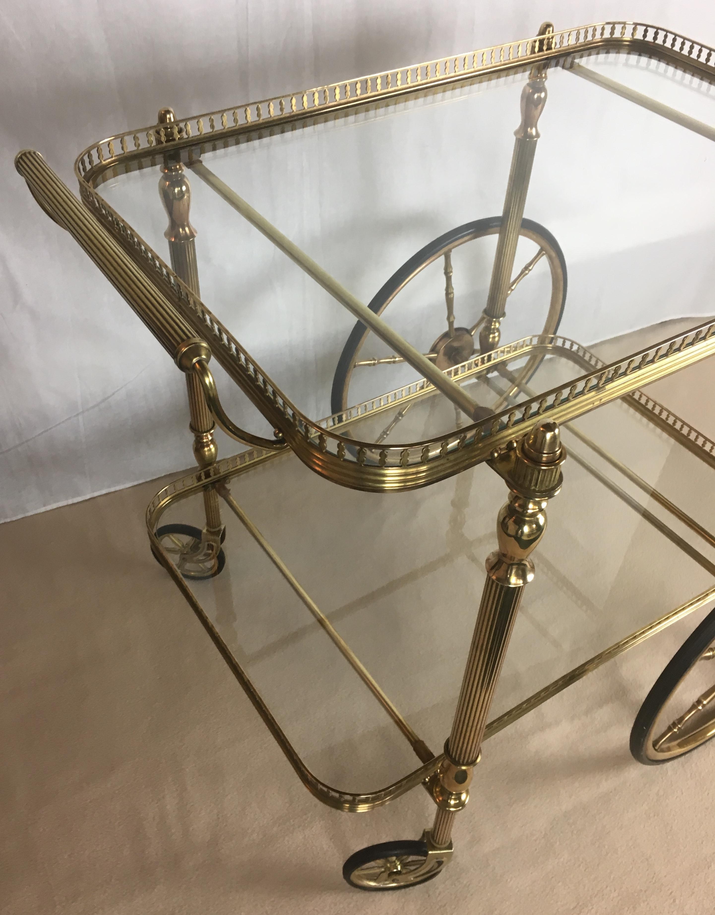 A gorgeous Neoclassical brass trolley or bar cart with two glass shelves, French, circa 1940. In the style of Maison Jansen.

Perfect in any living room, kitchen, study, office, even a bedroom.
 
Ships dismantled, easy to reassemble. If preferred,