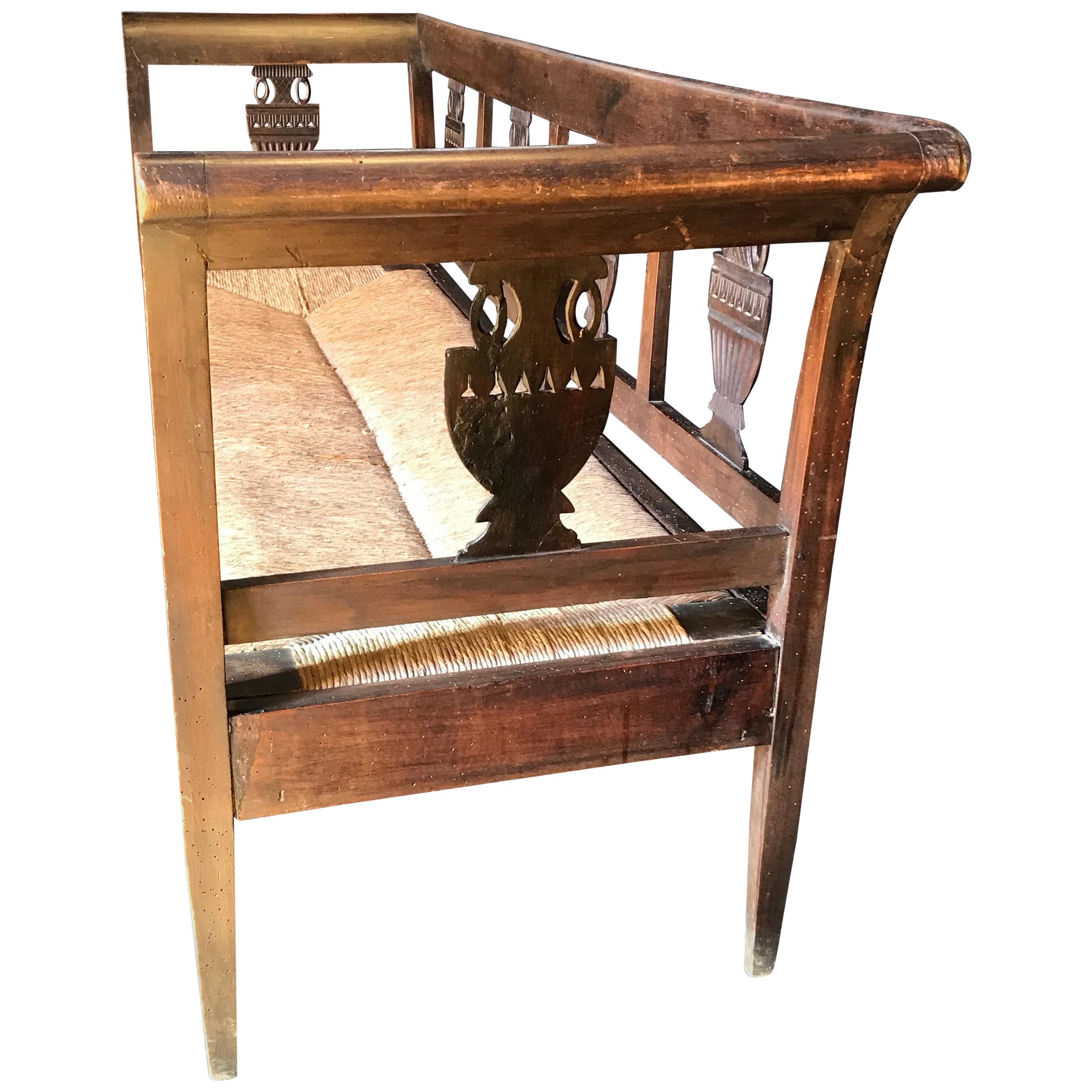 Very elegant walnut French bench having carved decorative urns around the back and sides, 5 legs in front, and handsome rush seat.
seat height 15.5