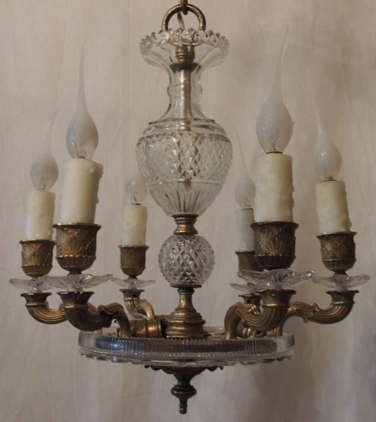 A very fine, French doré bronze and cut crystal neoclassical six-arm chandelier with three interior lights and six lights around the body.