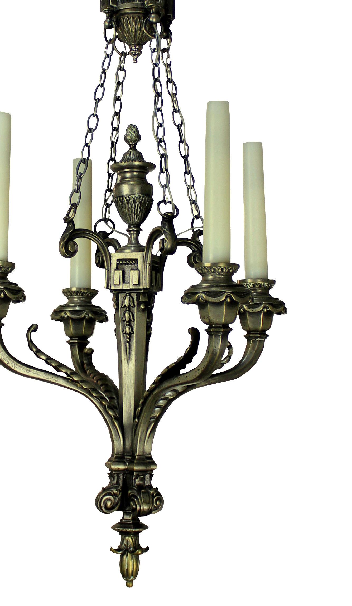 A French silver plated bronze four-branch chandelier in a neoclassical style.