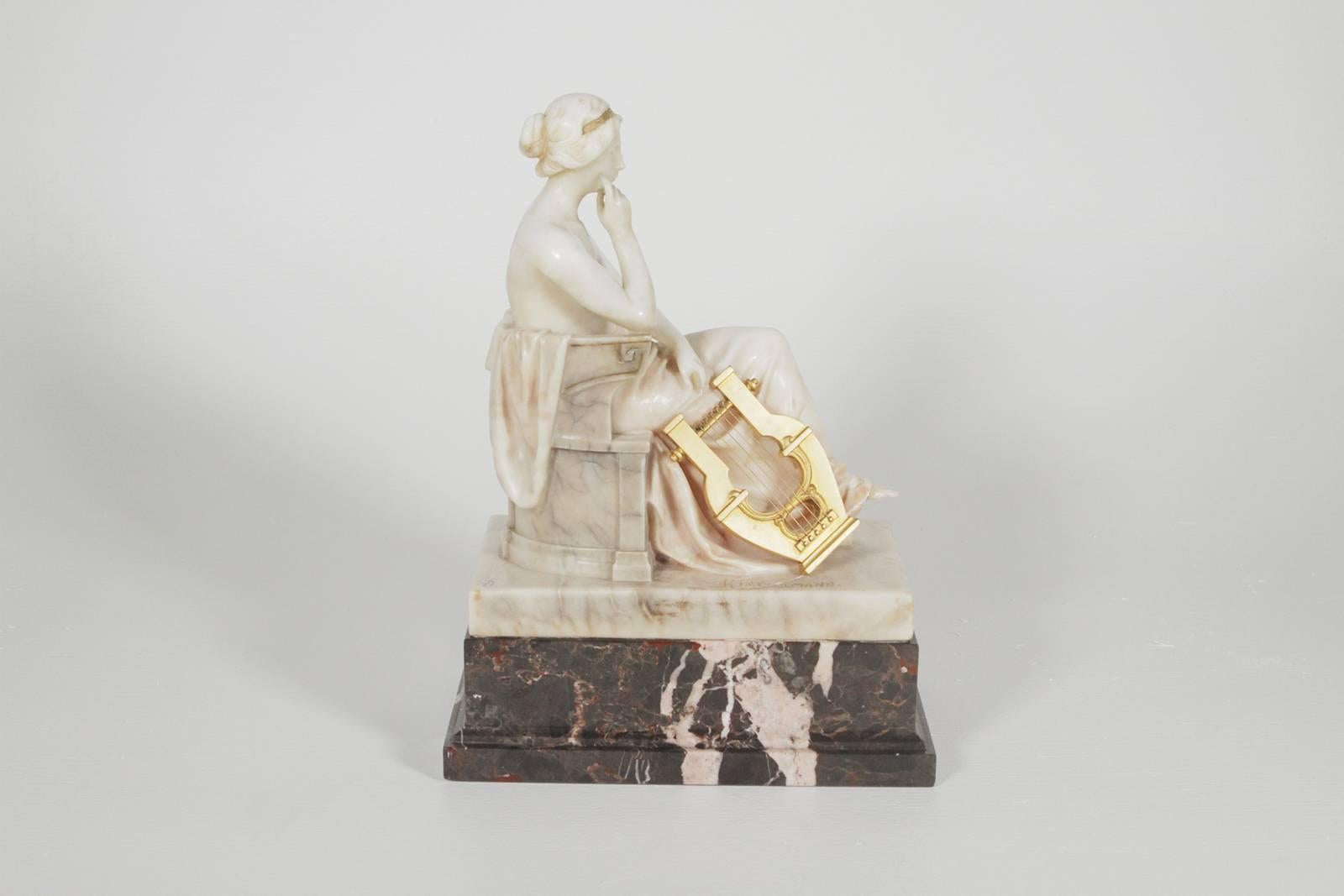German marble and ormolu sculpture of a seated muse with harp signed Hintzelman-WithGladenbeck-Berlin Seal Germany, circa 1910-1925 The gorgeous carved sculpture in Carrara marble resting on a black marble base with a gilt bronze harp. Measures: