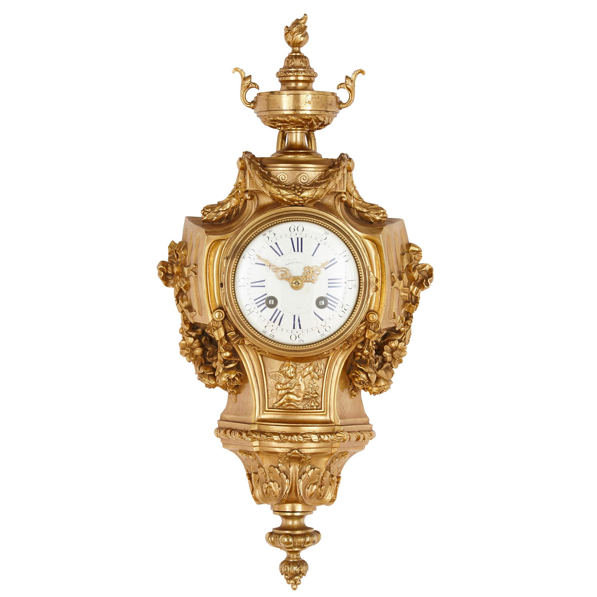 This beautiful clock and barometer are contained by matching gilt bronze cases, wrought in the elaborate Louis XVI style, the duo thus constituting a pair. The cases feature gilt bronze foliate mounts throughout. Below the dial of each instrument is