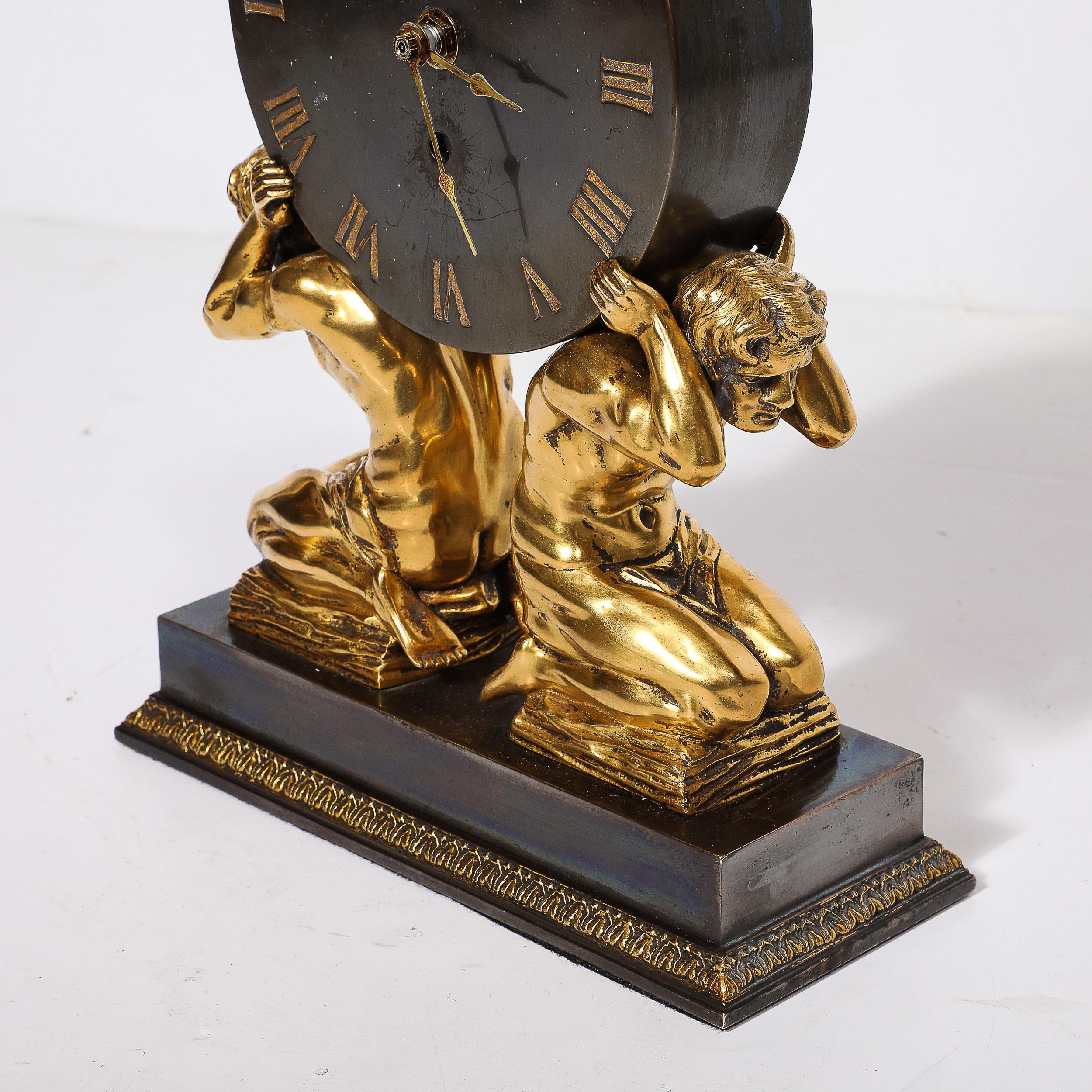 This stunning Neoclassical Gilt Bronze Mantlepiece Clock by Sterling Bronze Co. originates from the United States, Circa 1900. This clock is a fine example of Neoclassical design, featuring a gilt bronze sculptural support of kneeling figures on a