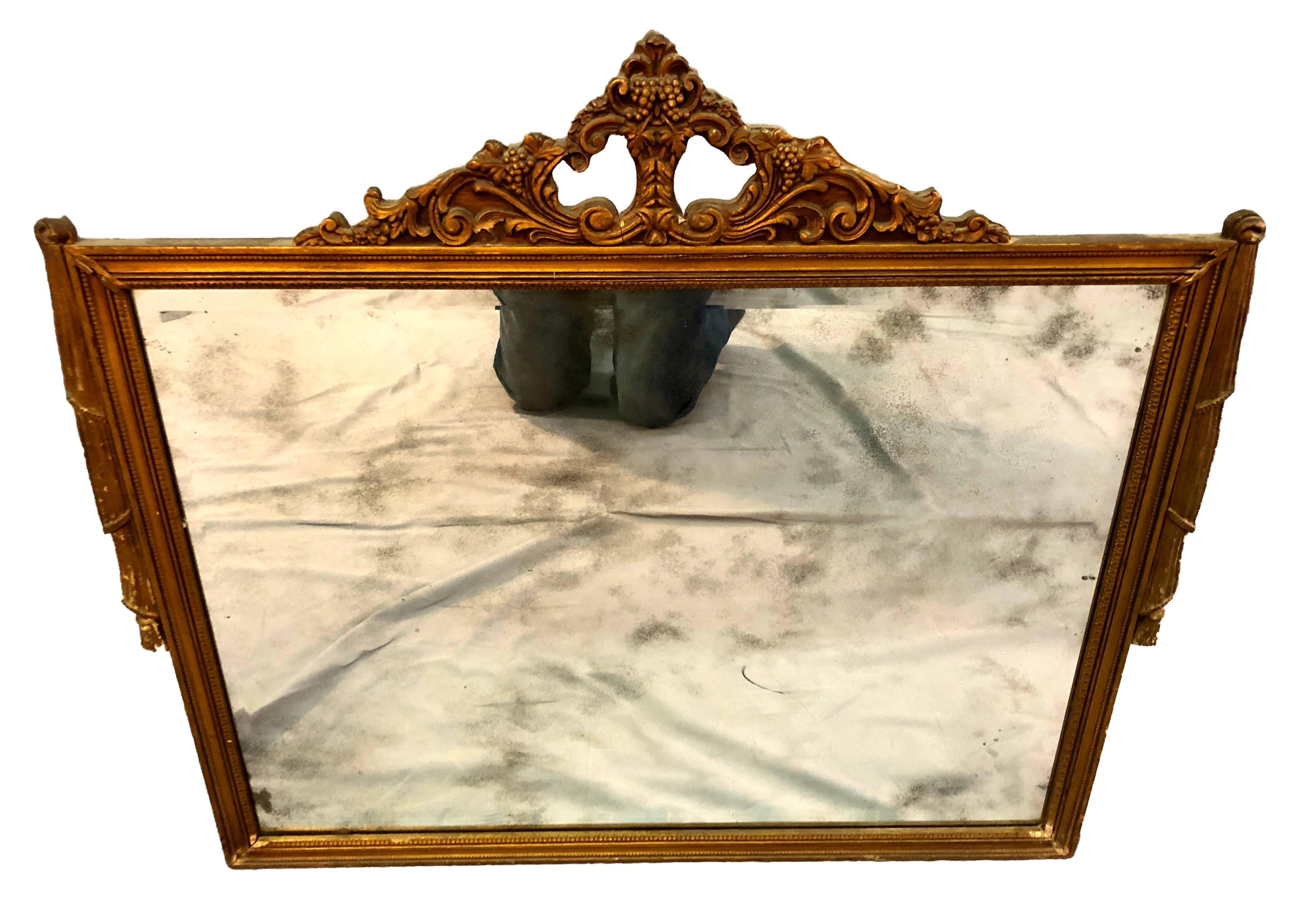 Early 1900s neoclassical gilt painted wood framed mirror. Spots of wear to the paint and age wear to the mirror. Hardware is included.
