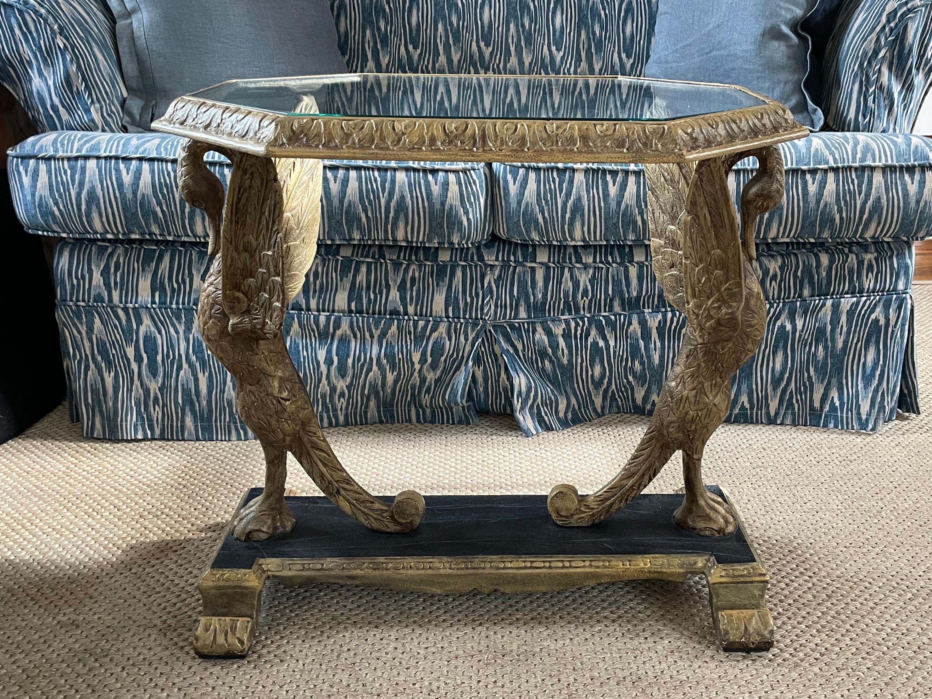 Neoclassical Gilt iron swan table. Antique neoclassical style cast iron side table/tea table of oblong octagonal form glass top framed by conforming acanthus leaf border supported by pair of swans with outstretched wings with webbed feet and outward