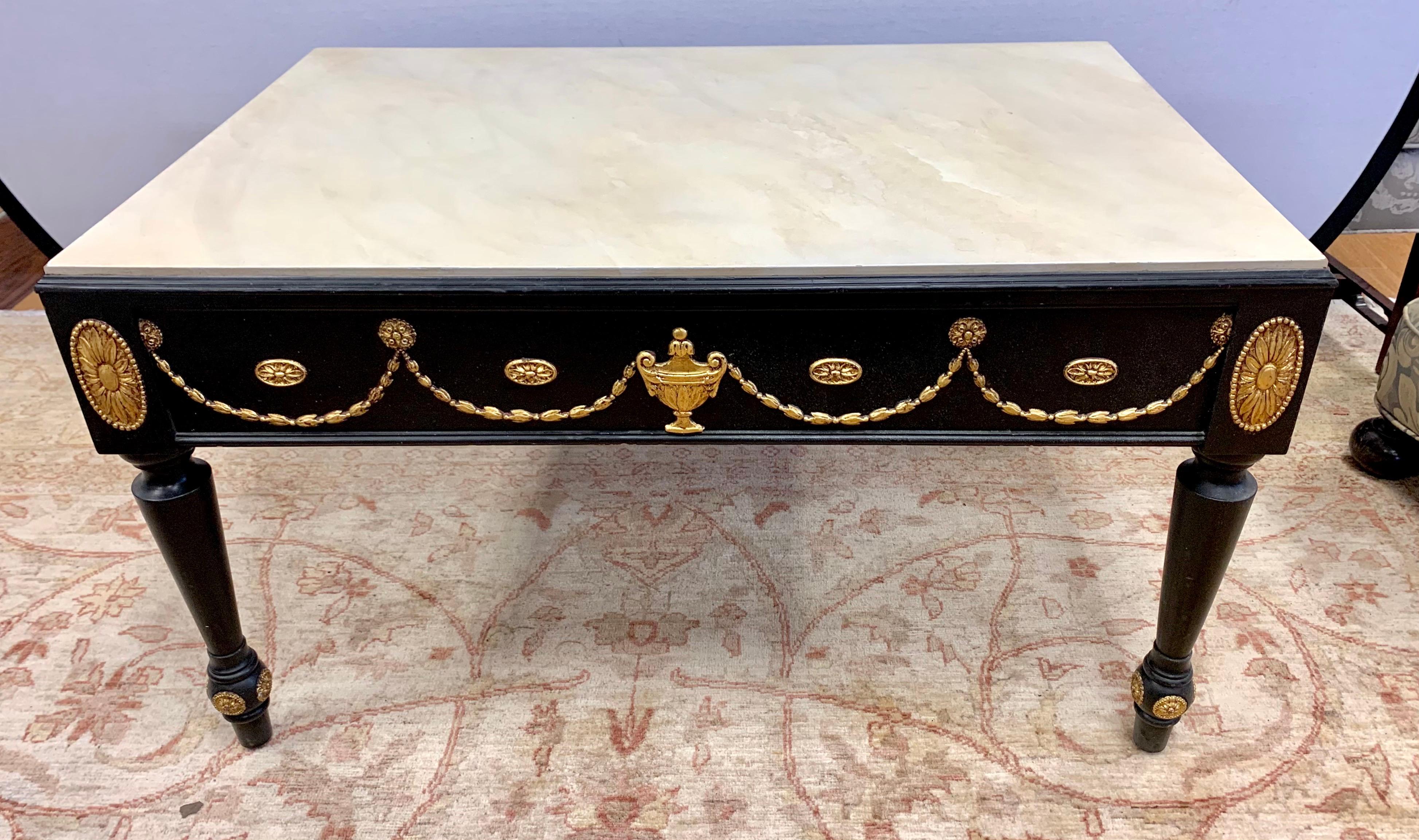 Modeled after a French antique, this hand painted black coffee table inspires a bit of 18th century refinement with a faux painted cream marble top and giltwood medallions and urns.