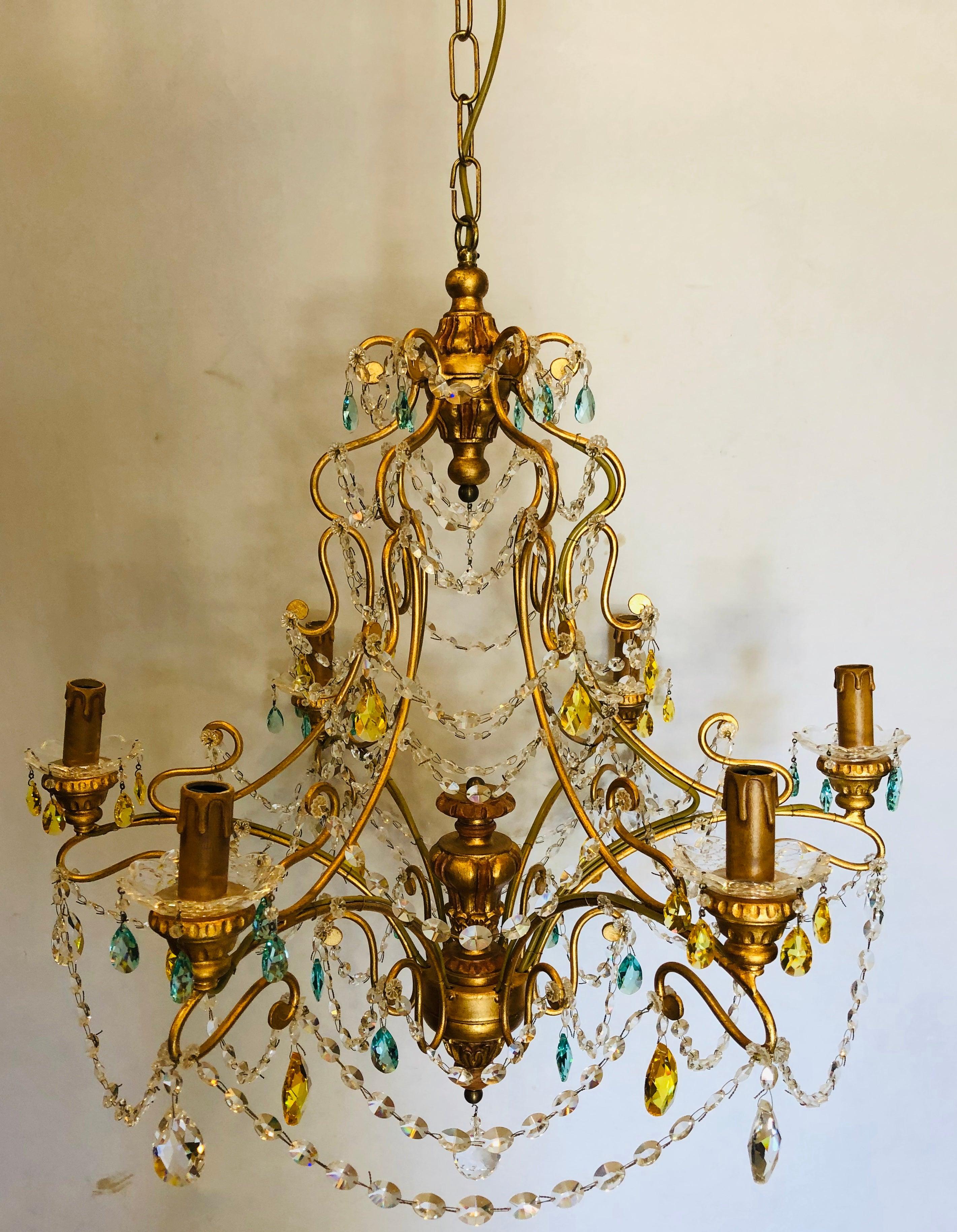 Neoclassical handcrafted Italian gilt metal and crystal chandelier. This sleek and stylish Murano crystal chandelier is reminiscent of the workmanship that has made Alba lighting a household name in the lighting industry. The fine wrought iron gilt