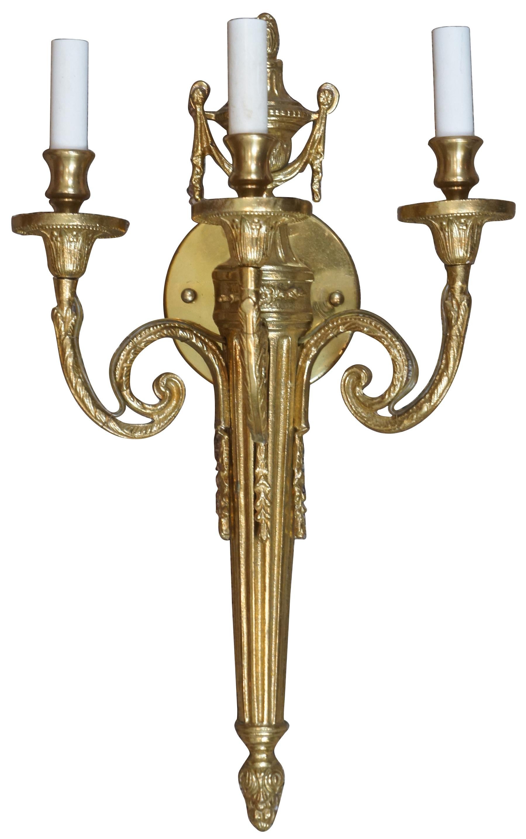 3 available, vintage neoclassical style brass wall sconce. Features a torchiere at the center splitting off into three scrolled candelabra lights. Measures: 20”.
   